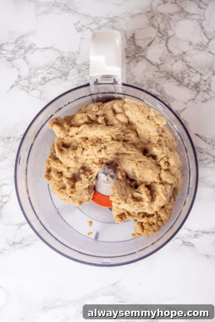 This homemade vegan turkey recipe is supremely flavourful and the perfect addition to any Thanksgiving table or holiday dinner! Overhead view of vegan turkey mixture in food processor bowl