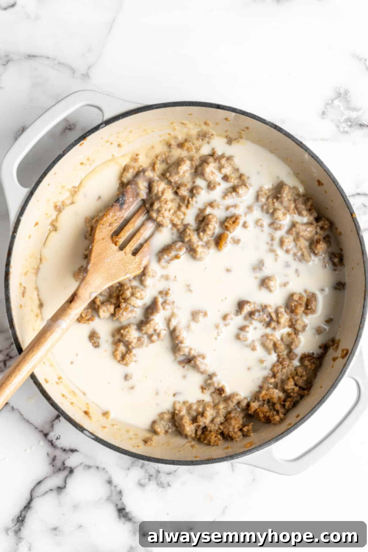 Cooked vegan sausage and a lot of vegan milk in a dutch oven with a slotted spoon