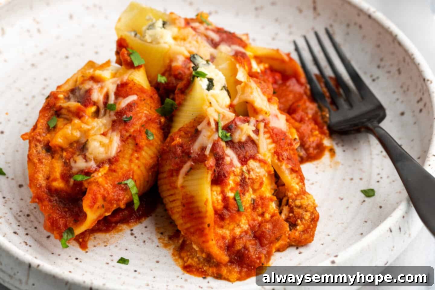Creamy Vegan Stuffed Shells 19 Closeup shot of perfectly baked vegan stuffed shells, showing the cheesy top and sauce