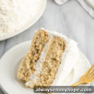 Tropical Vegan Coconut Cake 21 A charming close-up of a frosted slice of vegan coconut cake.