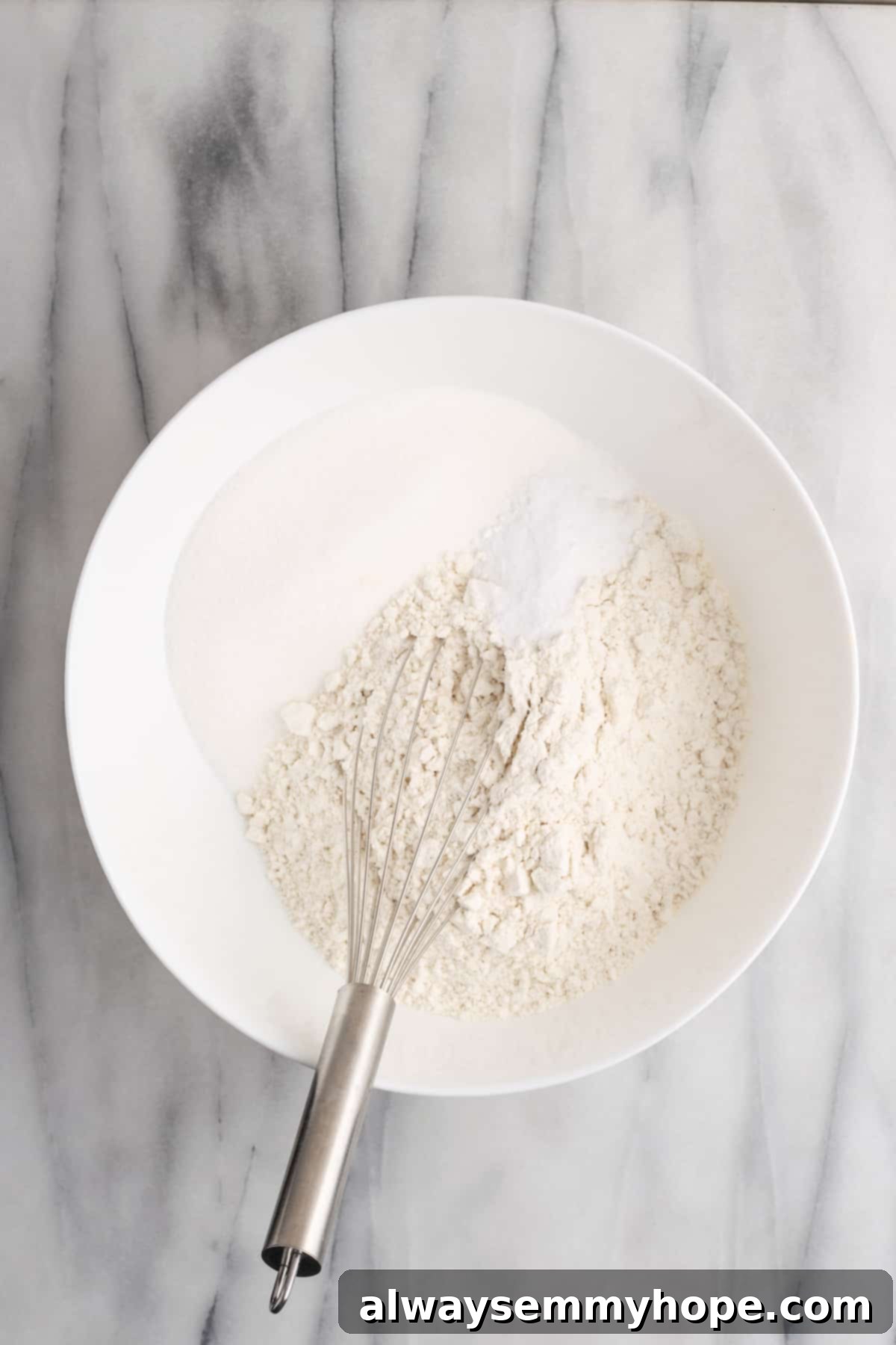 Tropical Vegan Coconut Cake 5 A bowl containing all the dry ingredients for the vegan coconut cake, perfectly mixed.