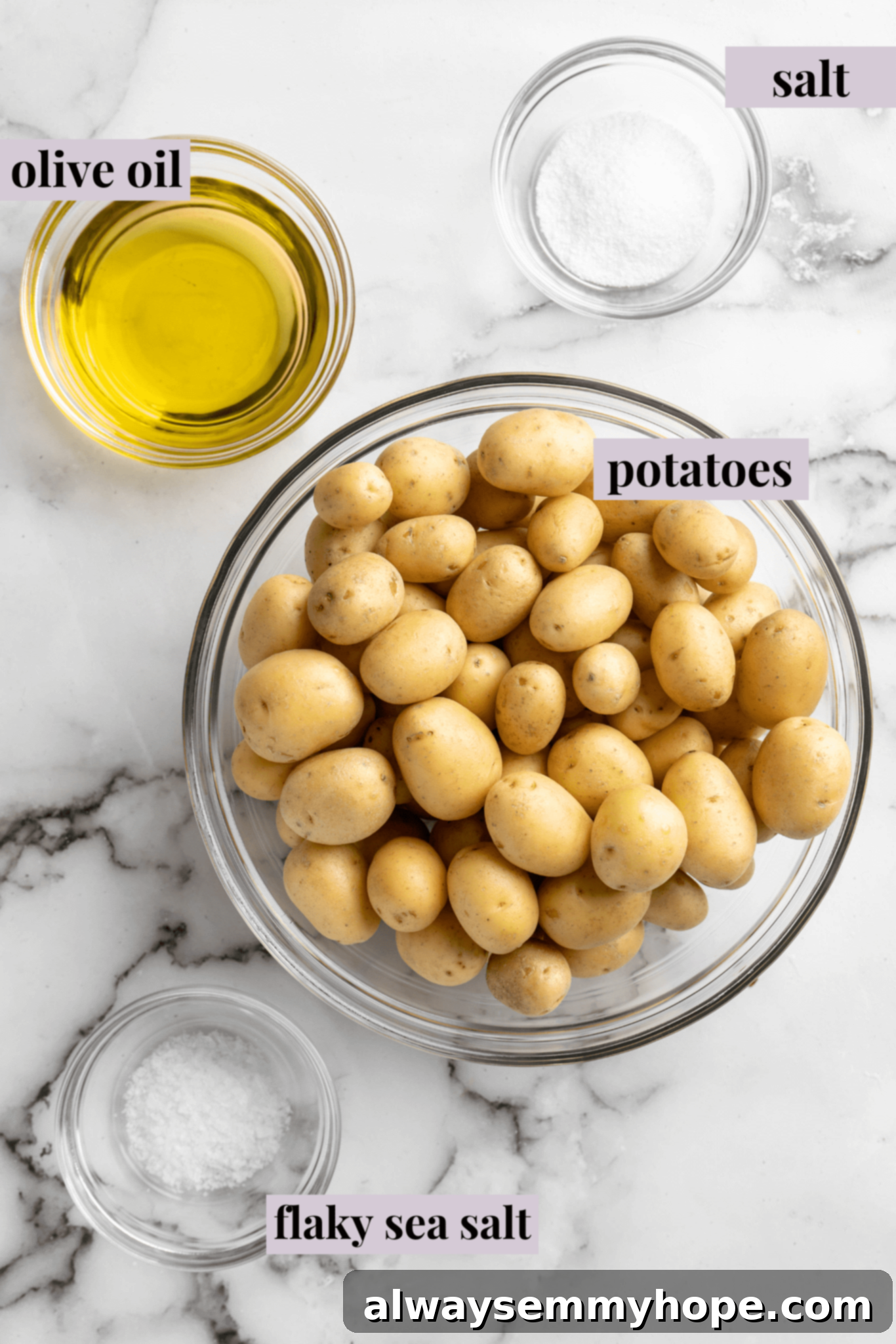 Ingredients for crispy smashed potatoes laid out on a wooden board