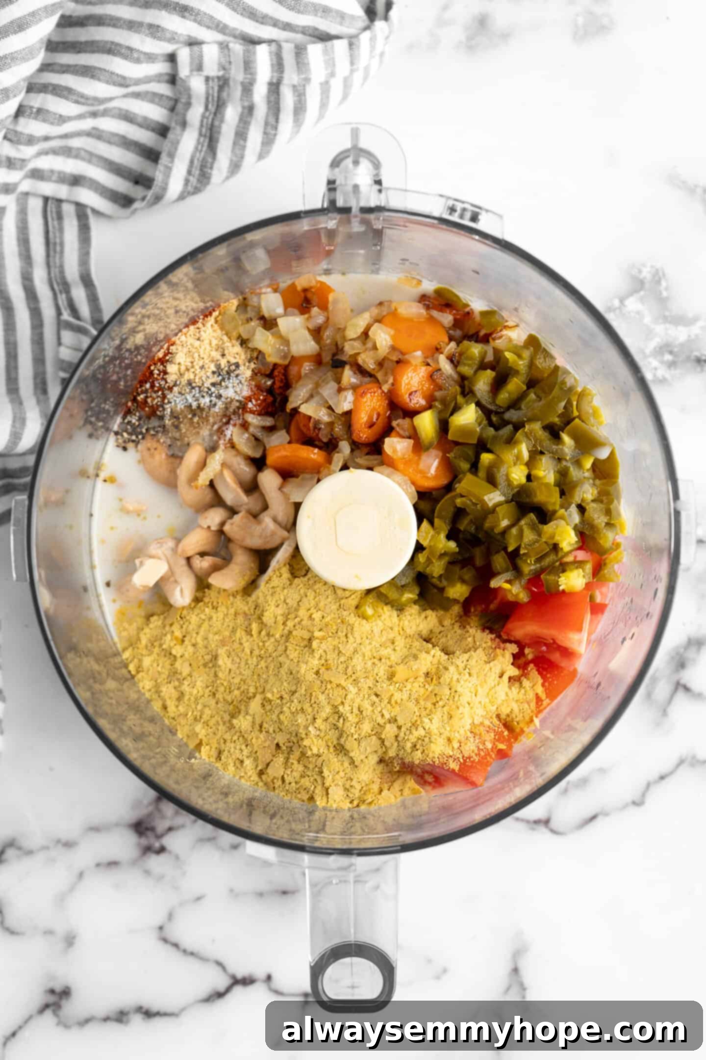 Ingredients for vegan queso in a food processor Ingredients for vegan queso in a food processor