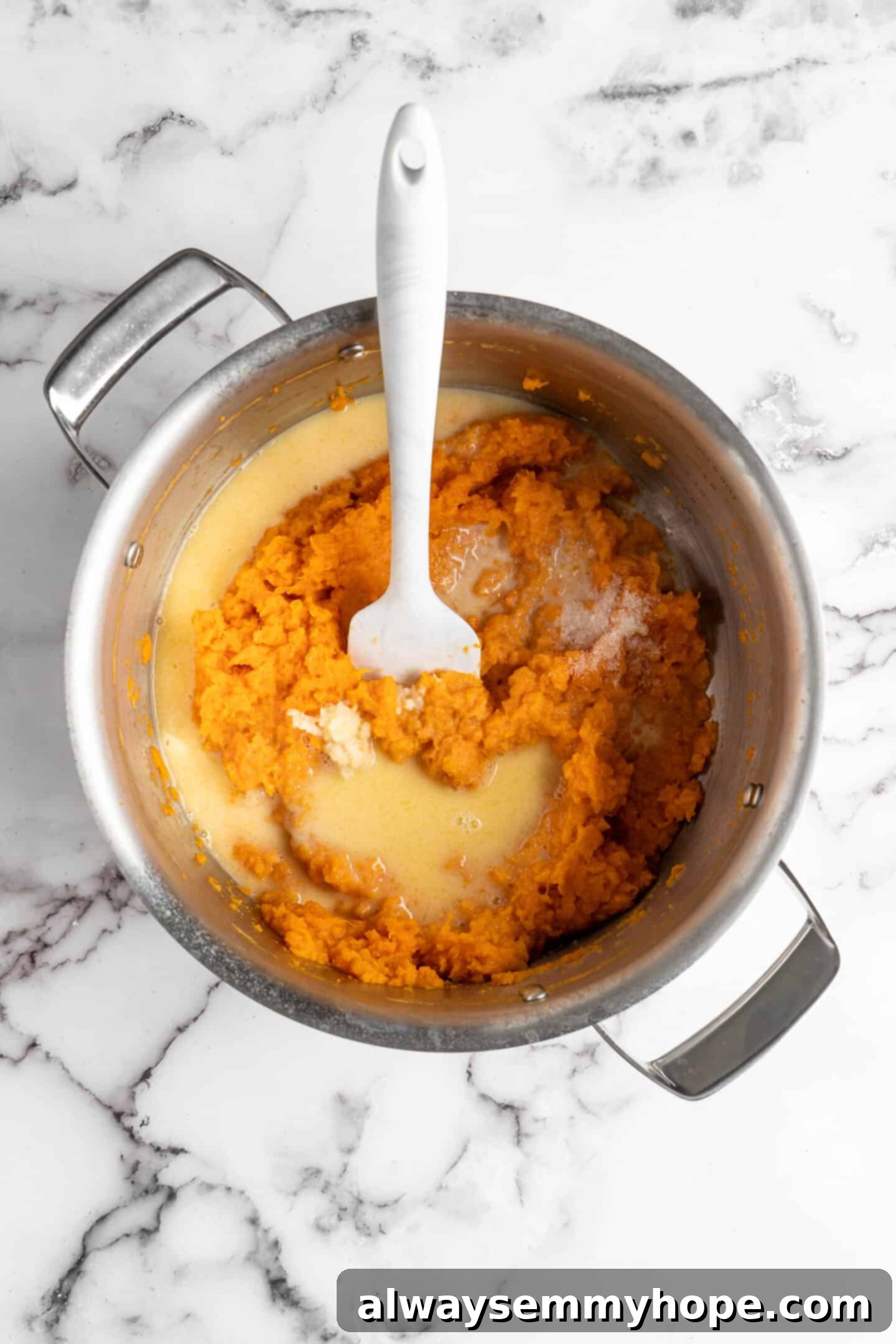 This recipe for vegan mashed sweet potatoes is like a whole holiday celebration in a bowl, but easy enough to make on a busy weeknight! Mashed sweet potatoes with the warmed vegan milk and butter mixture just added.