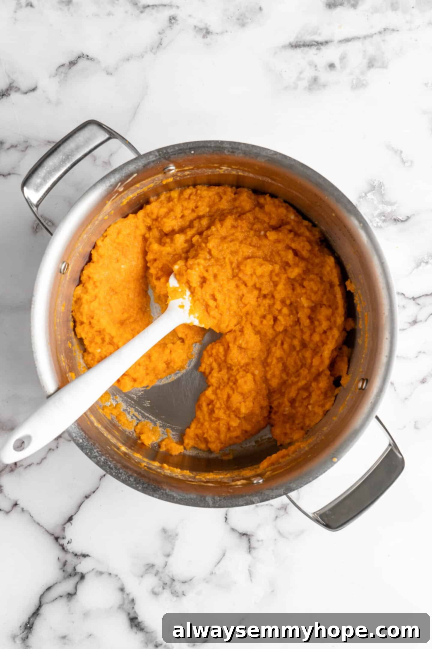 This recipe for vegan mashed sweet potatoes is like a whole holiday celebration in a bowl, but easy enough to make on a busy weeknight! Creamy vegan mashed sweet potatoes in a cooking pot, ready to be served.