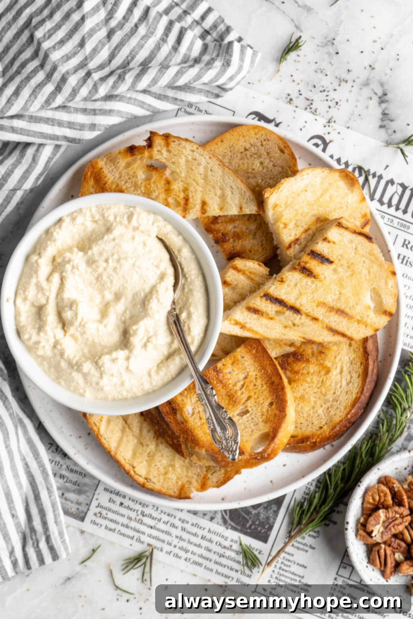 Discover the easiest, quickest, and tastiest vegan ricotta you’ll ever make at home – perfectly thick and creamy! Vegan ricotta dip on a toast platter, garnished with fresh herbs.
