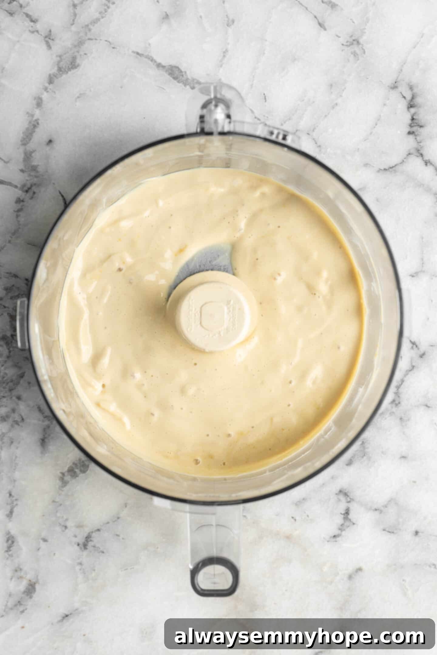 The smooth base for vegan ricotta, ready for the next step. Smooth base of vegan ricotta in a food processor.