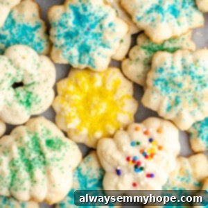 Melt-in-Your-Mouth Vegan Spritz Cookies 2 Overhead view of a pile of spritz cookies covered in different colors of sprinkles