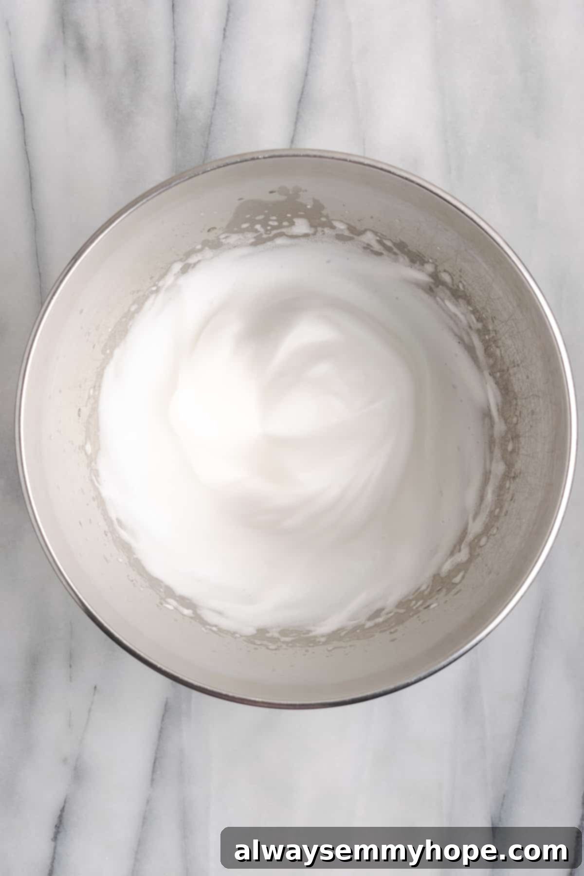 This rich and creamy vegan sweet potato soufflé recipe is a cozy Thanksgiving side. It's entirely vegan, and can easily be made gluten-free. A pristine mixing bowl showcasing beautifully whipped aquafaba, holding firm in stiff, cloud-like peaks, ready to be folded.