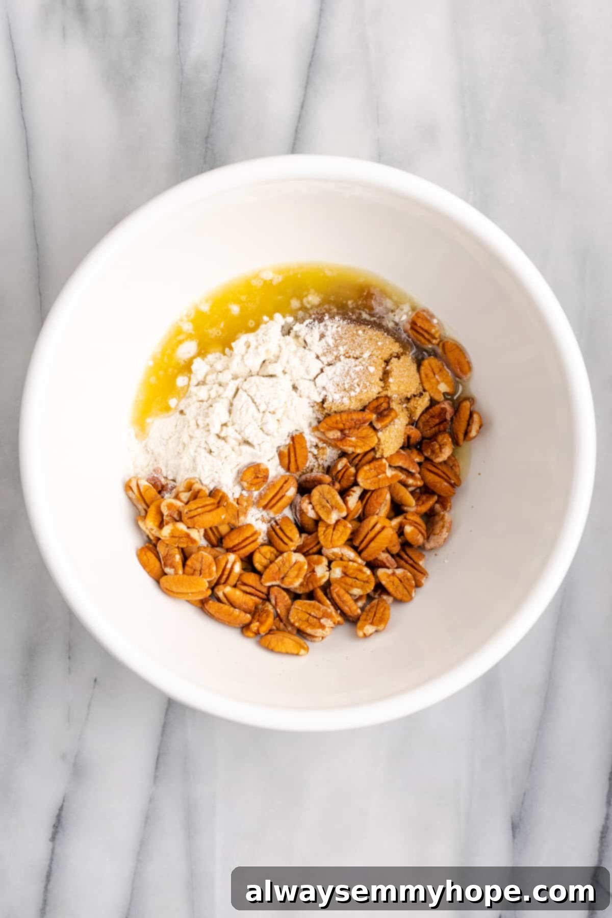 This rich and creamy vegan sweet potato soufflé recipe is a cozy Thanksgiving side. It's entirely vegan, and can easily be made gluten-free. A mixing bowl containing the dry ingredients for the topping: flour, brown sugar, vegan butter, and whole pecan halves, awaiting combination.