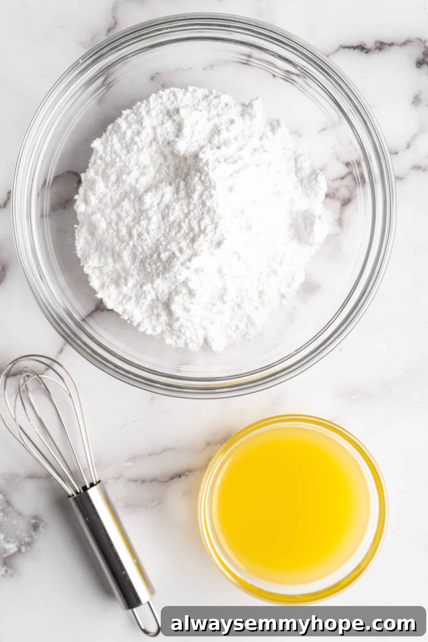 This moist cranberry walnut bread has just the right balance of sweetness, nuttiness, and tartness, and is a perfect holiday treat. A bowl of finely sifted powdered sugar sits next to a bowl of fresh orange juice, with a whisk laid beside them, ready for glaze preparation.