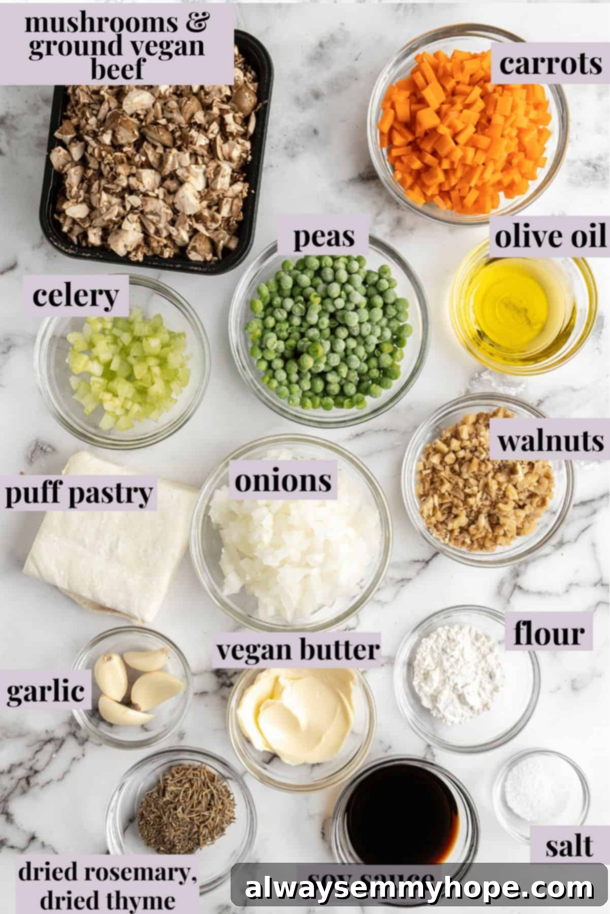 This vegan wellington recipe uses mushrooms, walnuts, and vegan beef to replace meat. It's a hearty holiday meal that's easy to make. A clear glass bowl filled with the fresh ingredients required for Vegan Wellington, including vibrant green peas, a block of vegan butter, a package of ground vegan beef, diced carrots, onions, and celery, fresh mushrooms, garlic cloves, and a bag of walnuts, all neatly arranged on a rustic wooden surface.