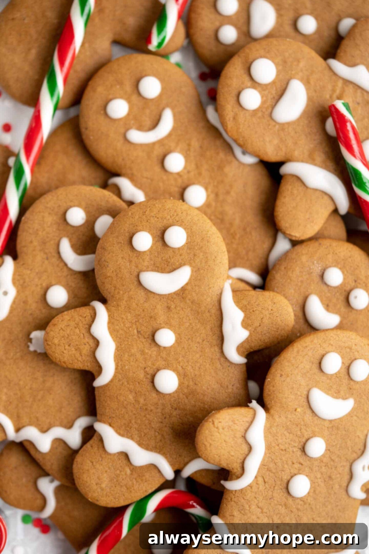 Close up of a pile of decorated gingerbread men with candycanes