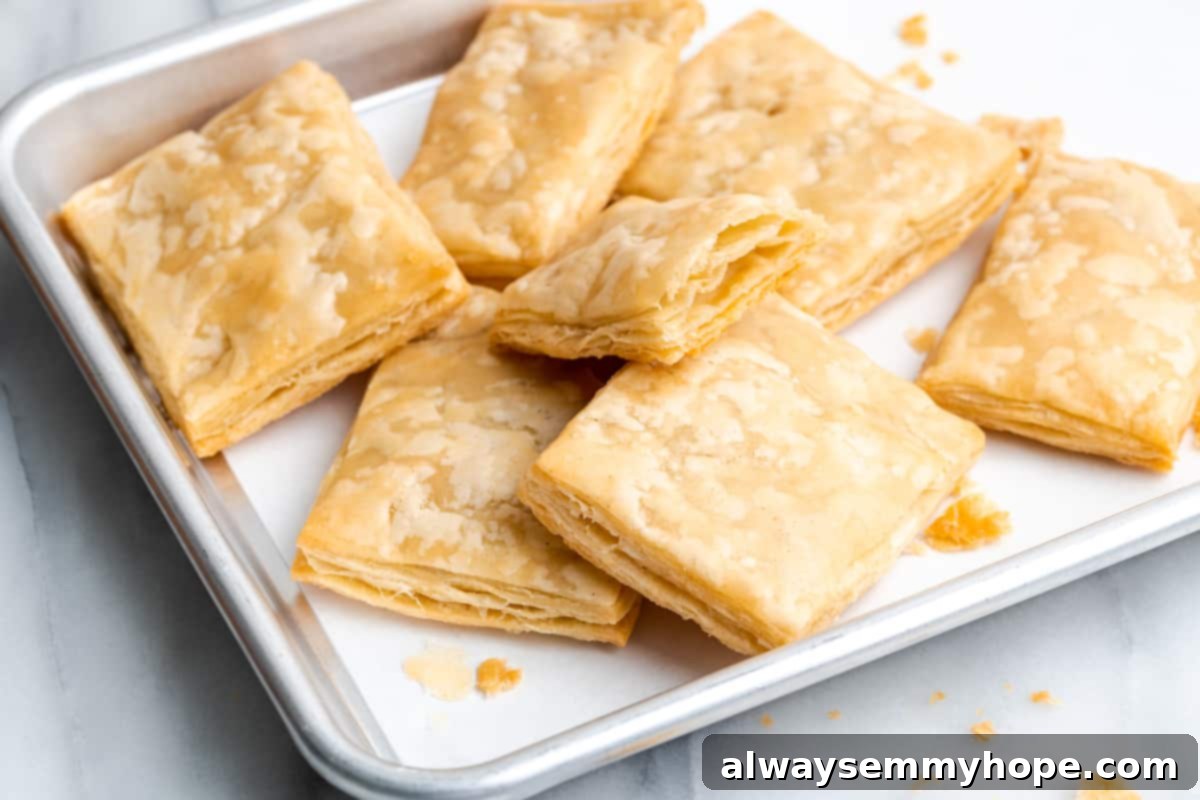 Squares of baked puff pastry on a baking sheet