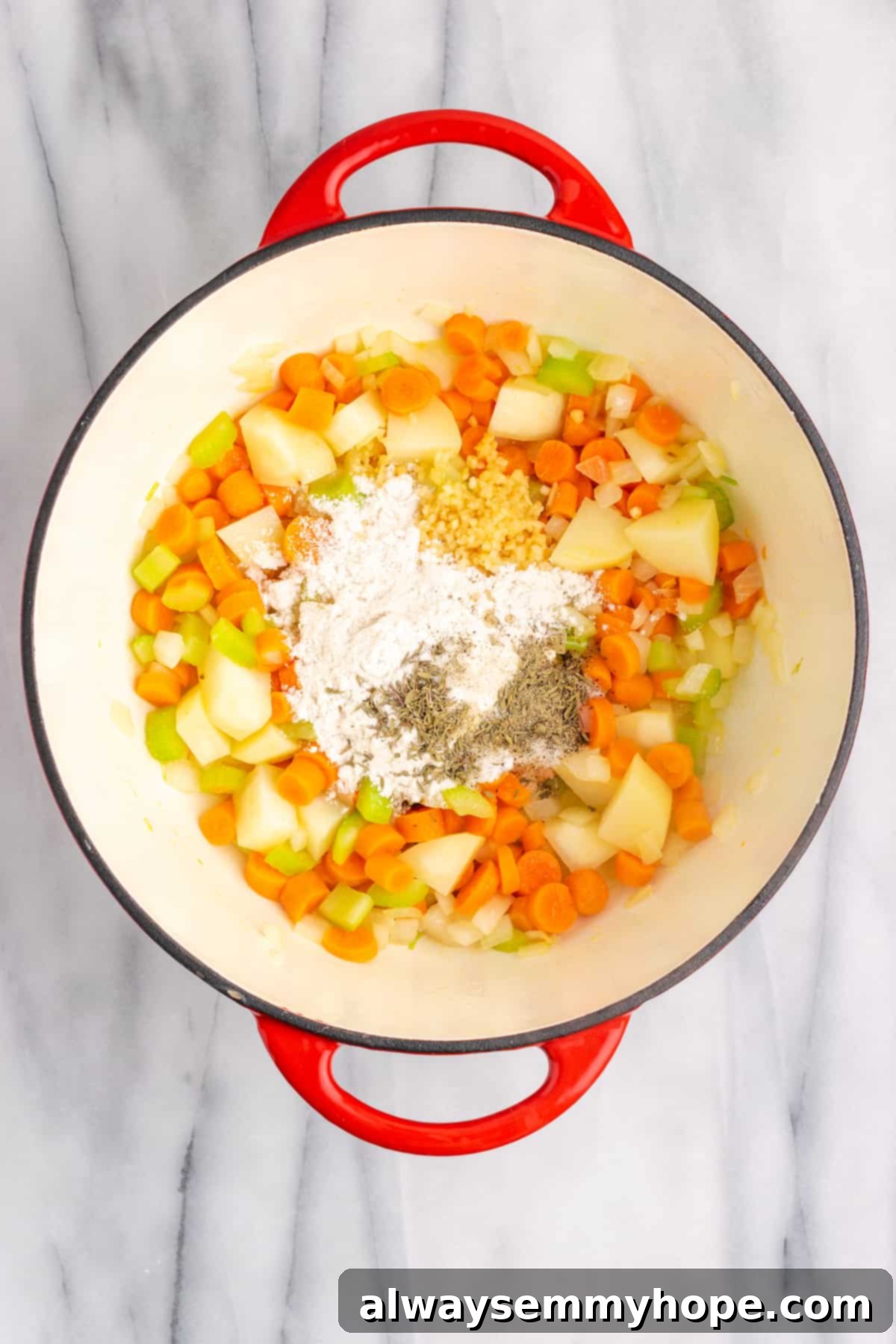 A Dutch oven containing cooked vegetables, with flour, salt, pepper, and thyme sprinkled on top, ready to be stirred in.