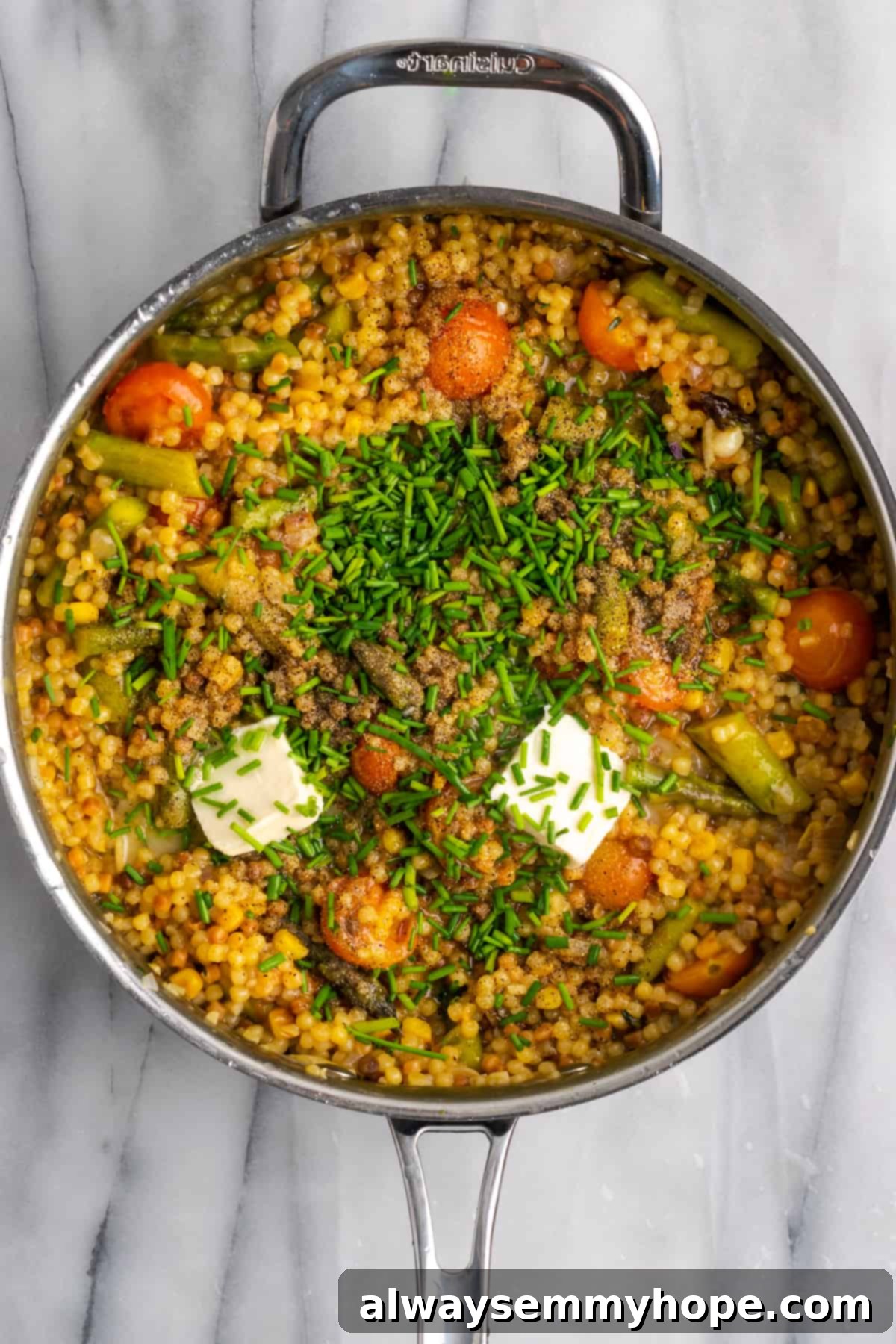 Hearty Vegan Fregola Pasta in Skillet. Another overhead shot of the fully cooked vegan fregola in the skillet, showcasing the harmonious blend of pasta, vegetables, and sauce, before final garnishes are added.