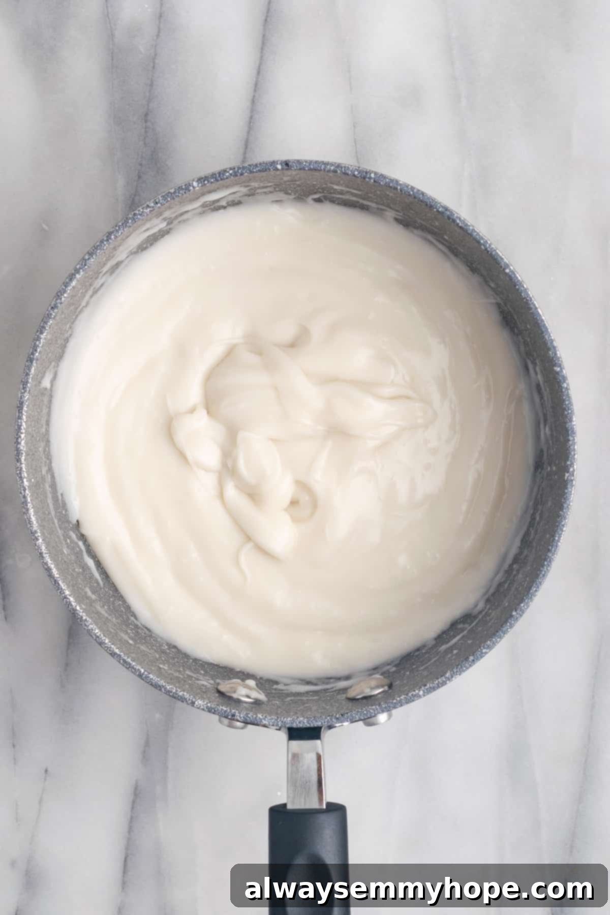 Hawaiian Coconut Haupia 8 Close-up of the haupia mixture simmering in a pan, showing its thickening consistency as it's whisked.