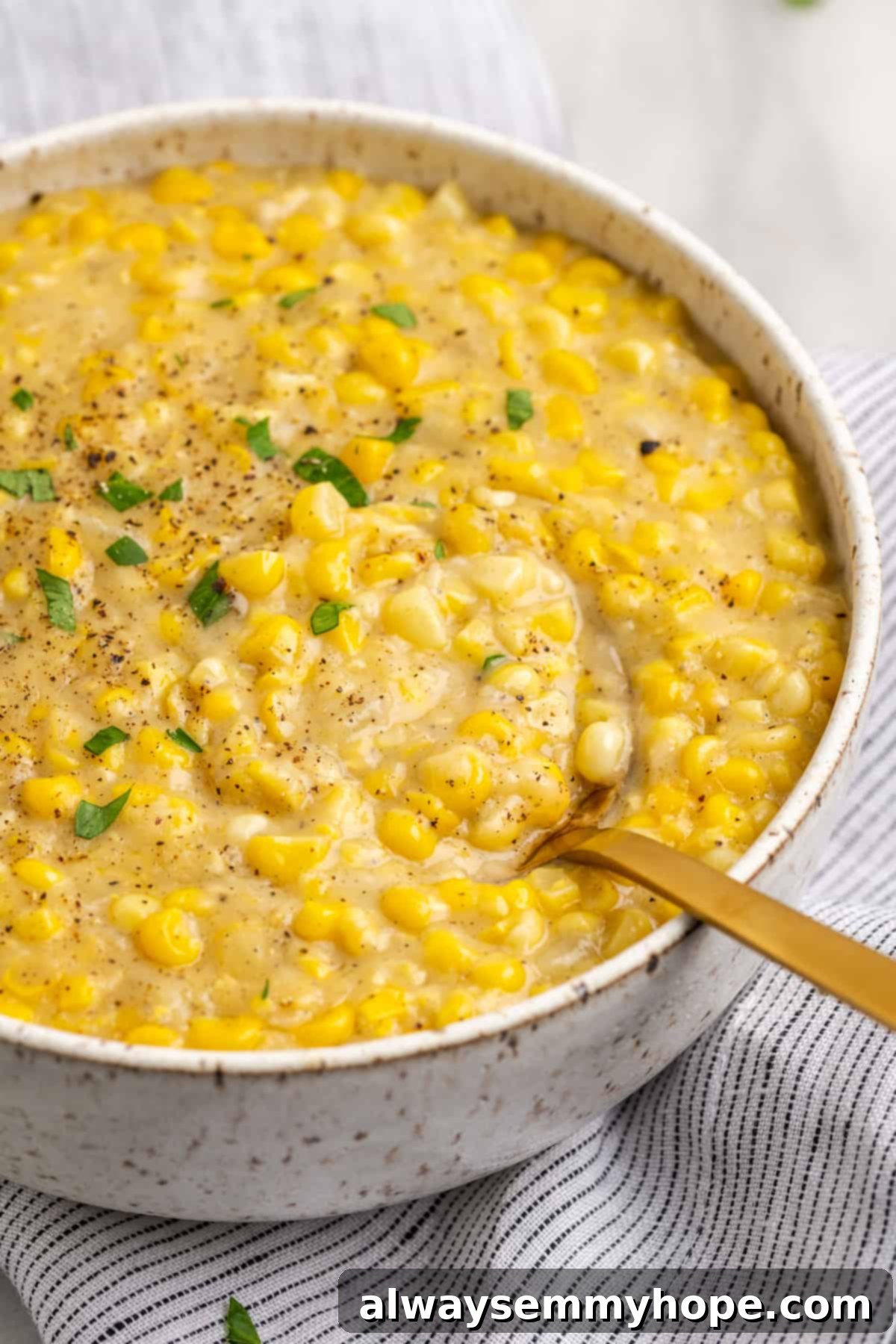 Vegan creamed corn in serving bowl with spoon