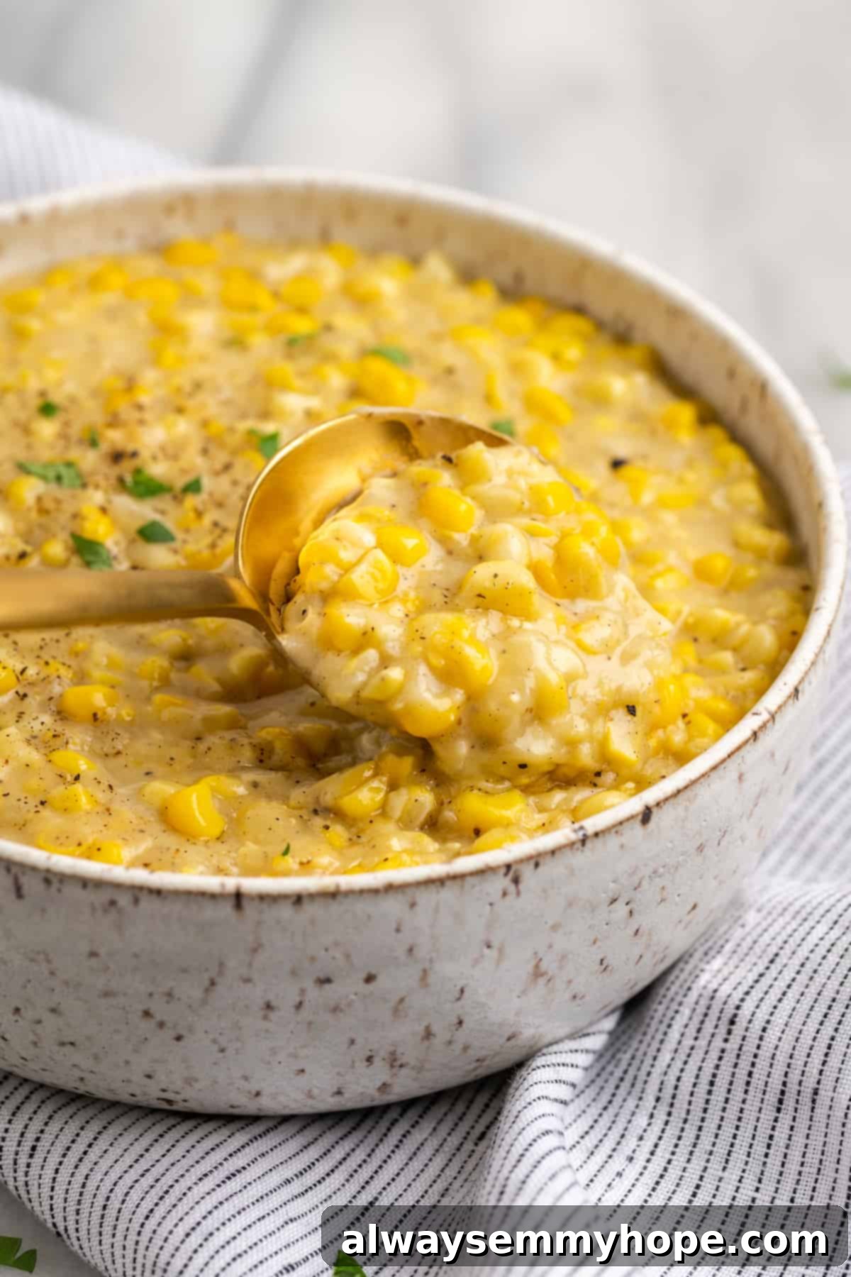 Spoon lifting vegan creamed corn from bowl