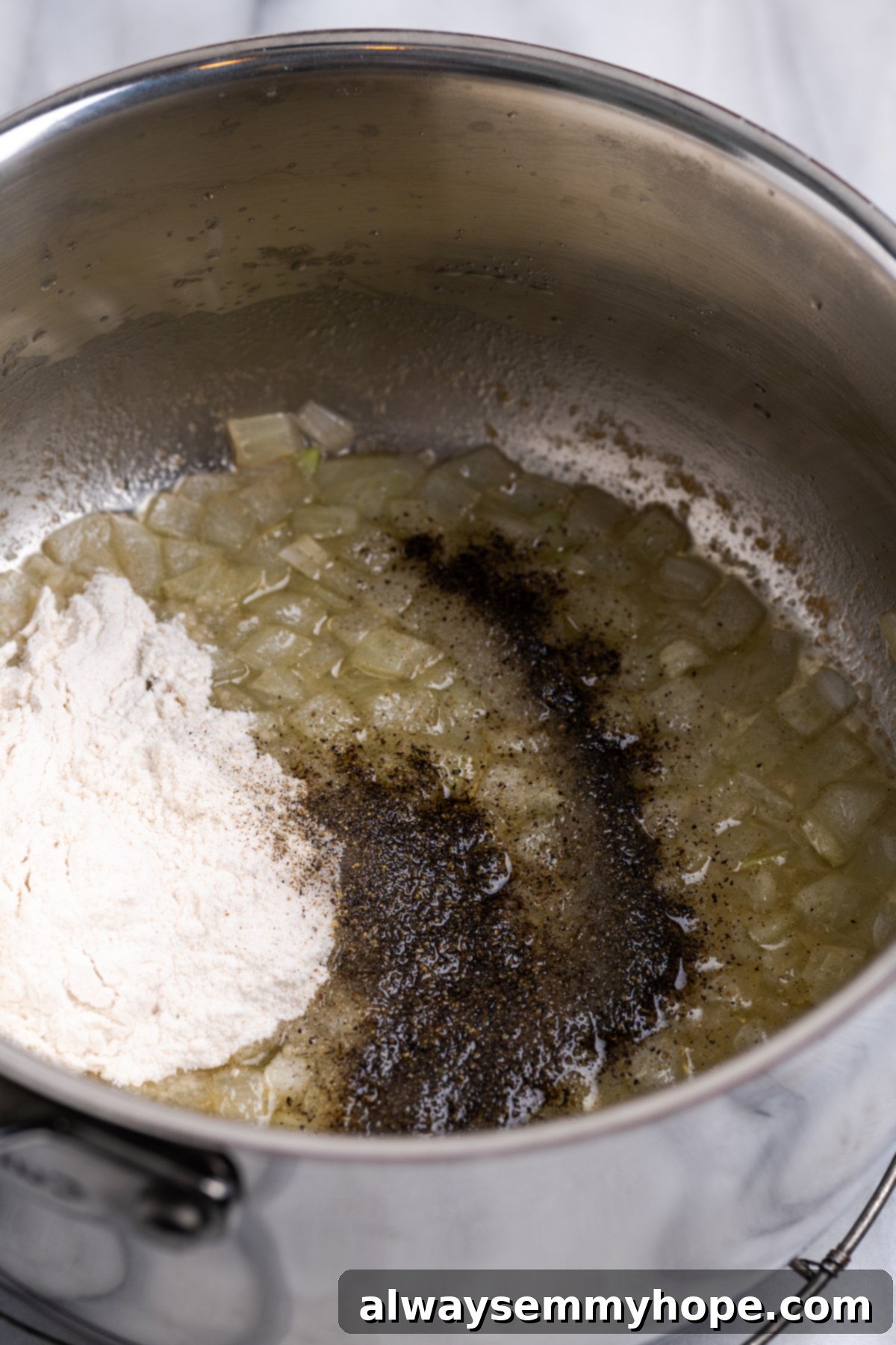 Flour and seasonings in pot with sauteed onions