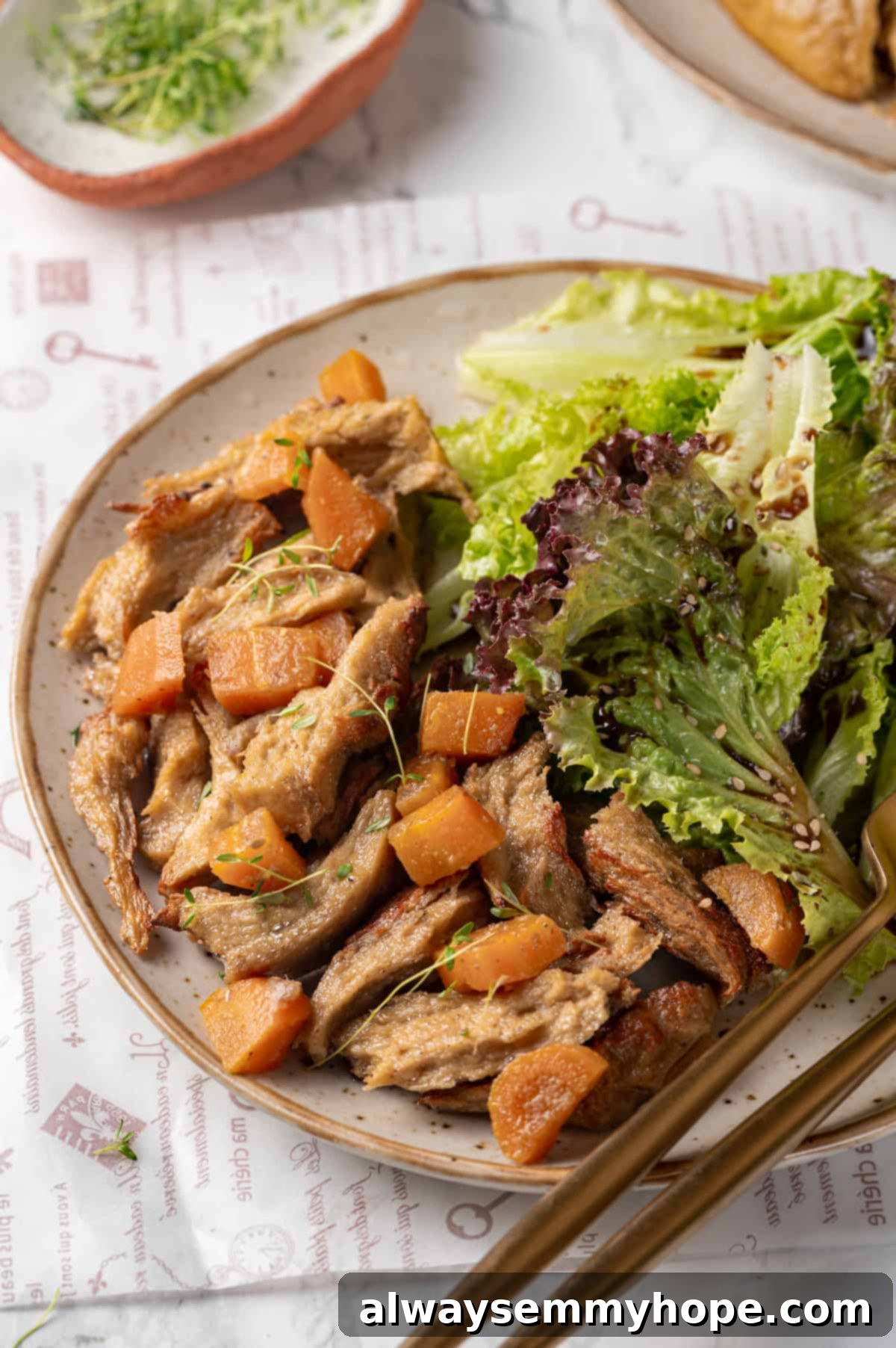Savory homemade vegan chicken served on a plate with fresh salad and perfectly roasted carrots, showcasing its appealing texture and golden-brown exterior.