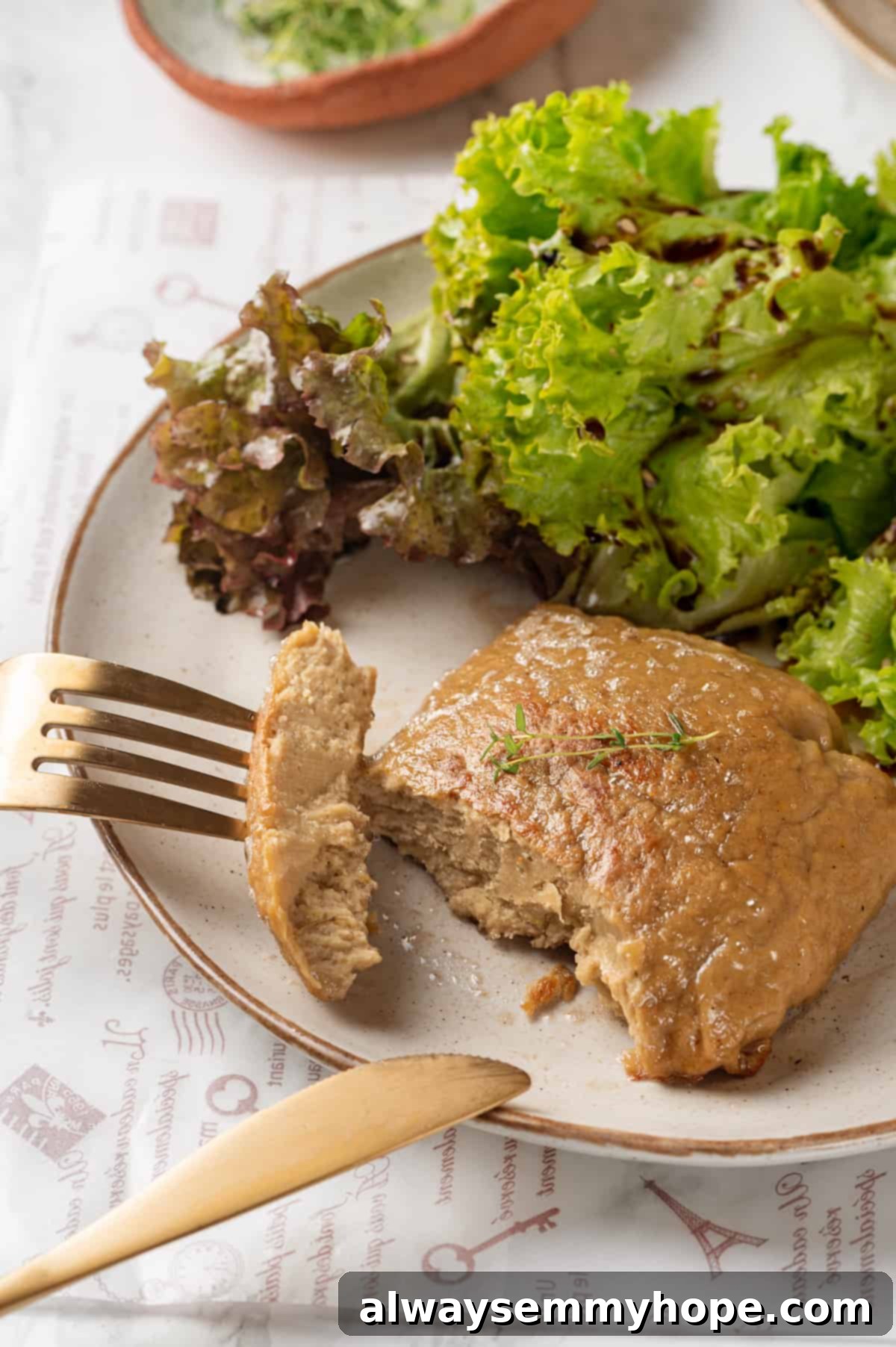 A large slab of homemade vegan chicken with a piece torn off on a fork, highlighting its realistic, shreddable texture.
