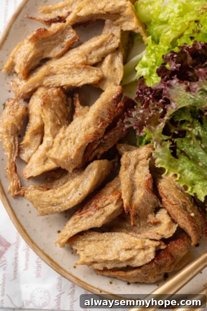A close-up shot of a single piece of homemade vegan chicken on a plate, highlighting its detailed texture.