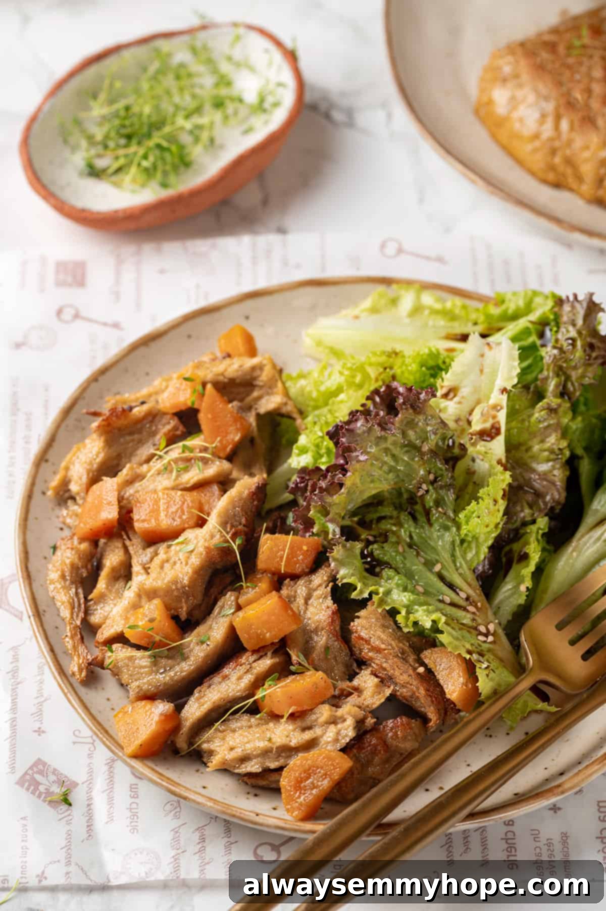 A beautifully arranged plate of homemade vegan chicken served alongside fresh salad and perfectly roasted carrots.