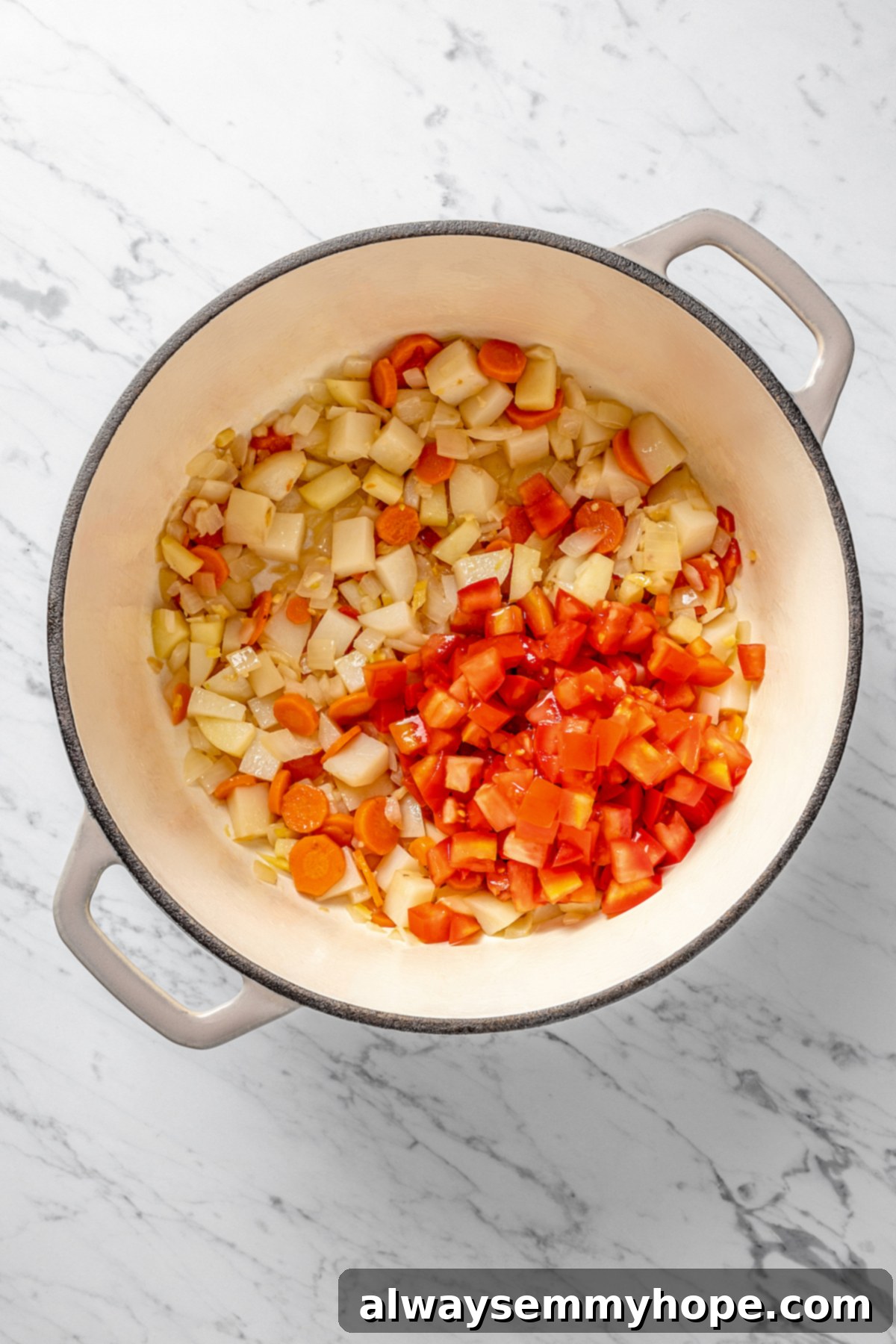 Overhead view of sautéed vegetables in a pot, slightly browned and tender.
