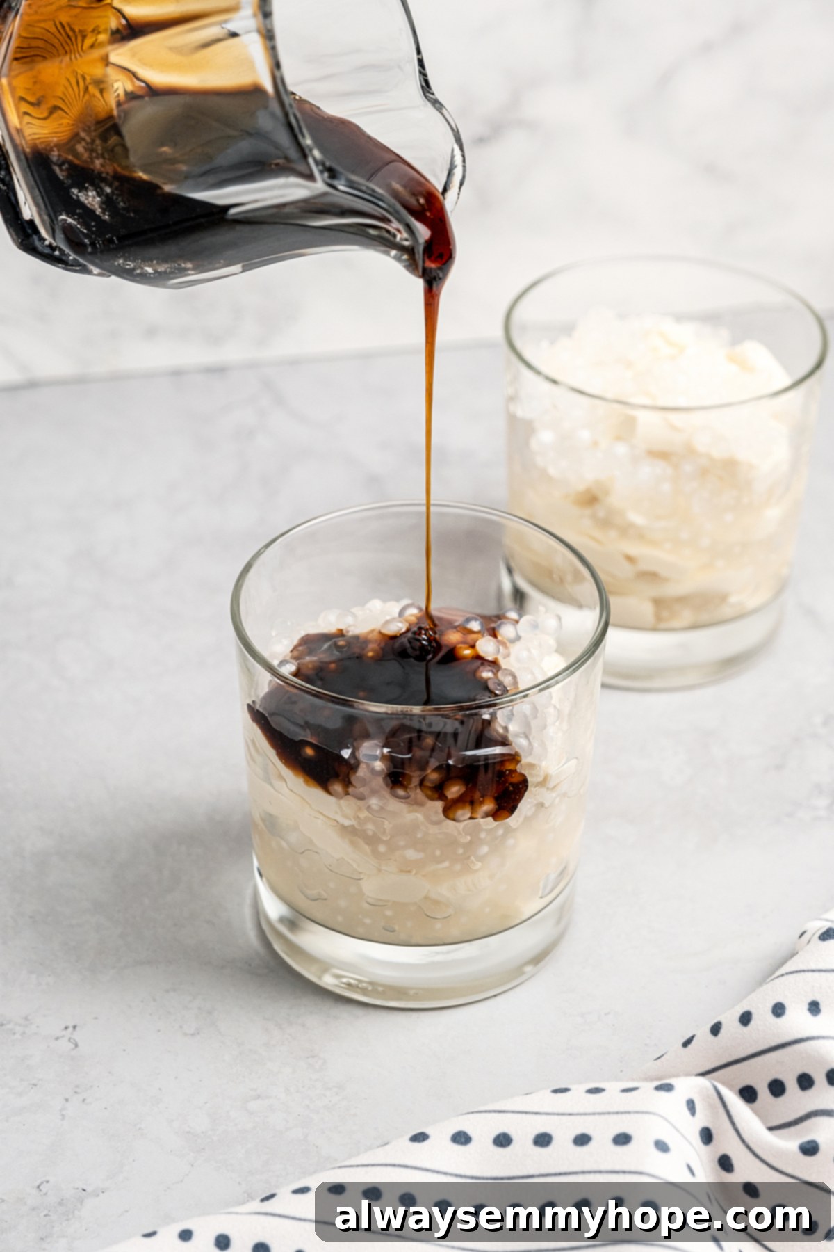 Pouring syrup into glass with tofu and sago