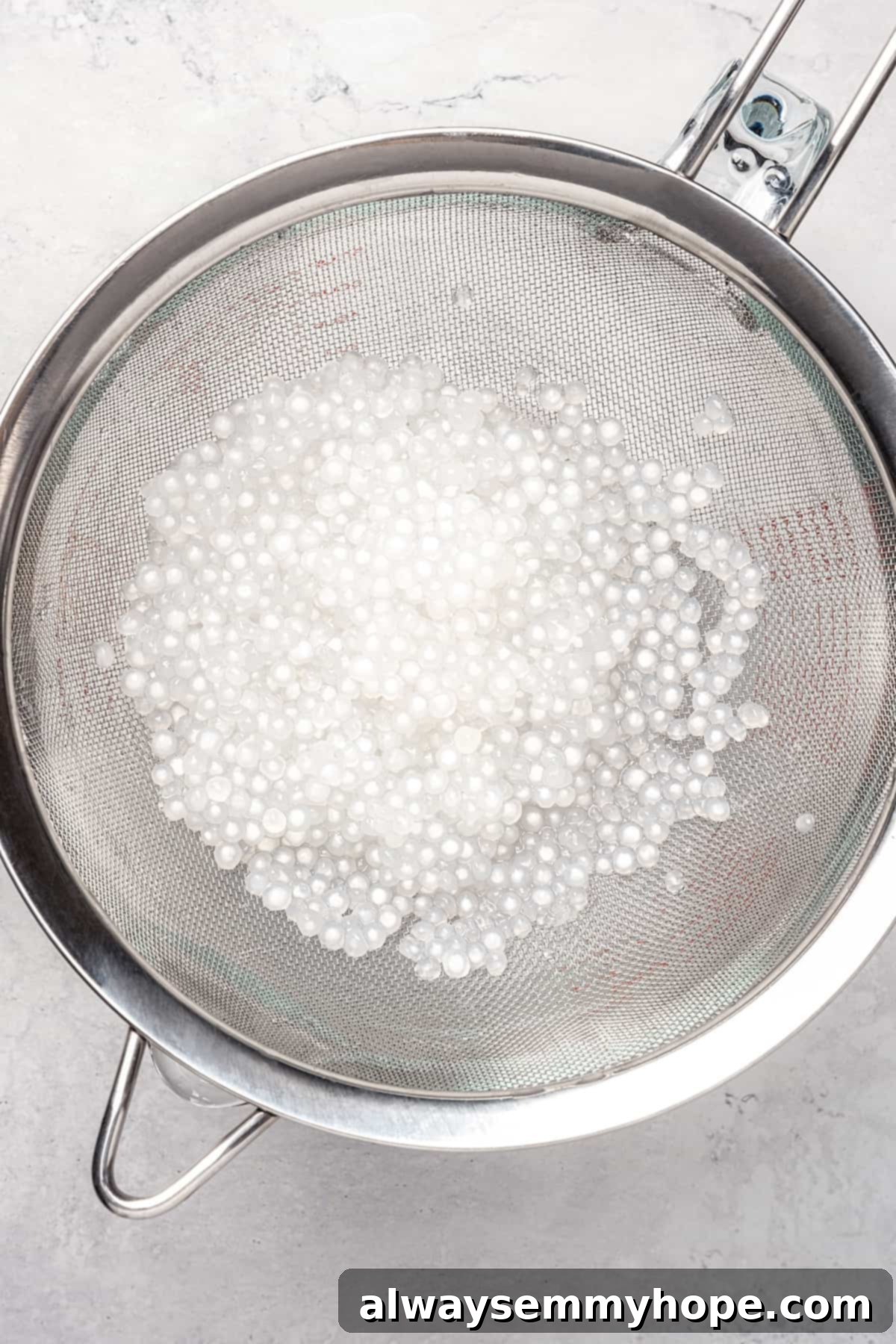 Sago pearls in fine mesh strainer