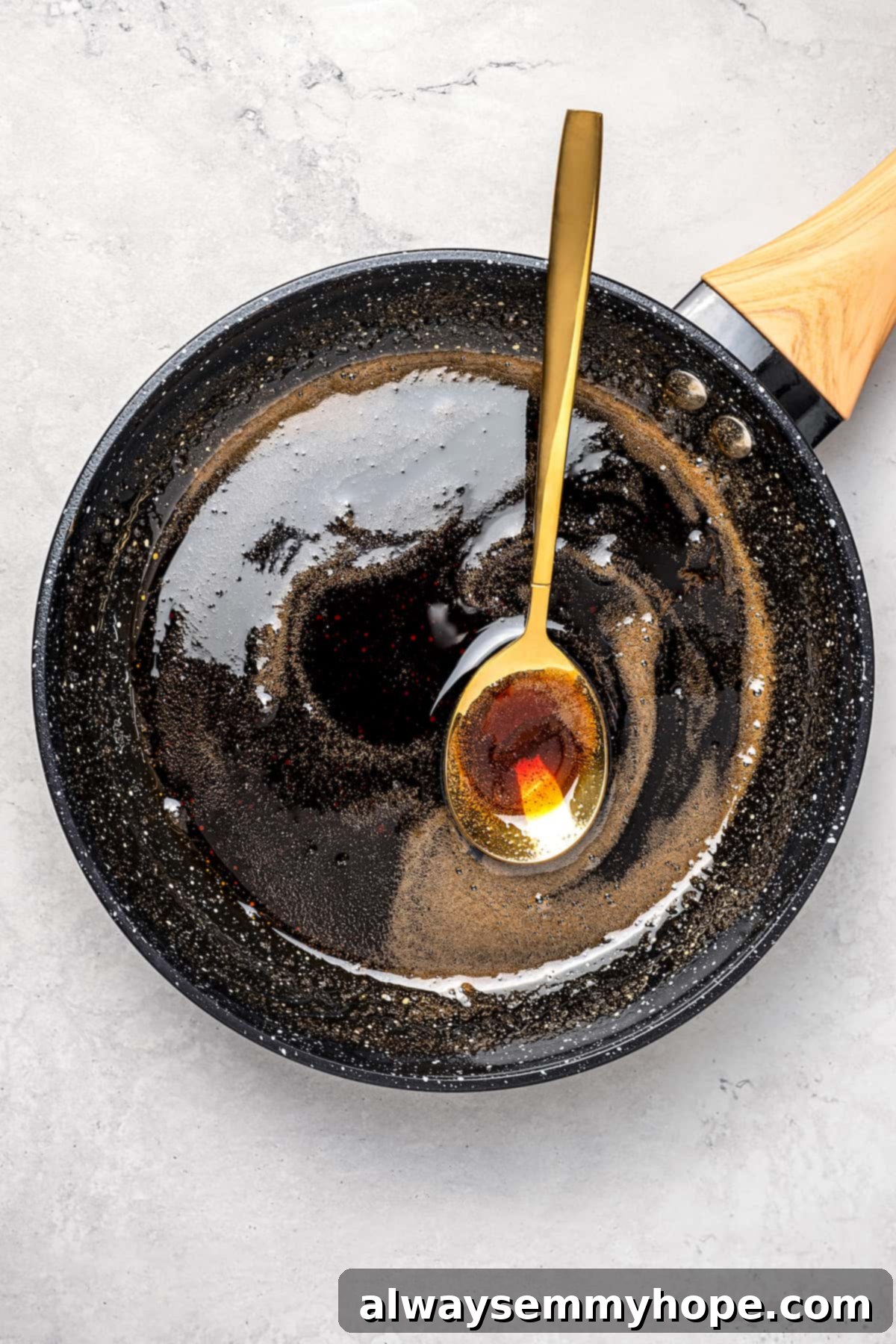 Arnibal syrup in saucepan with spoon