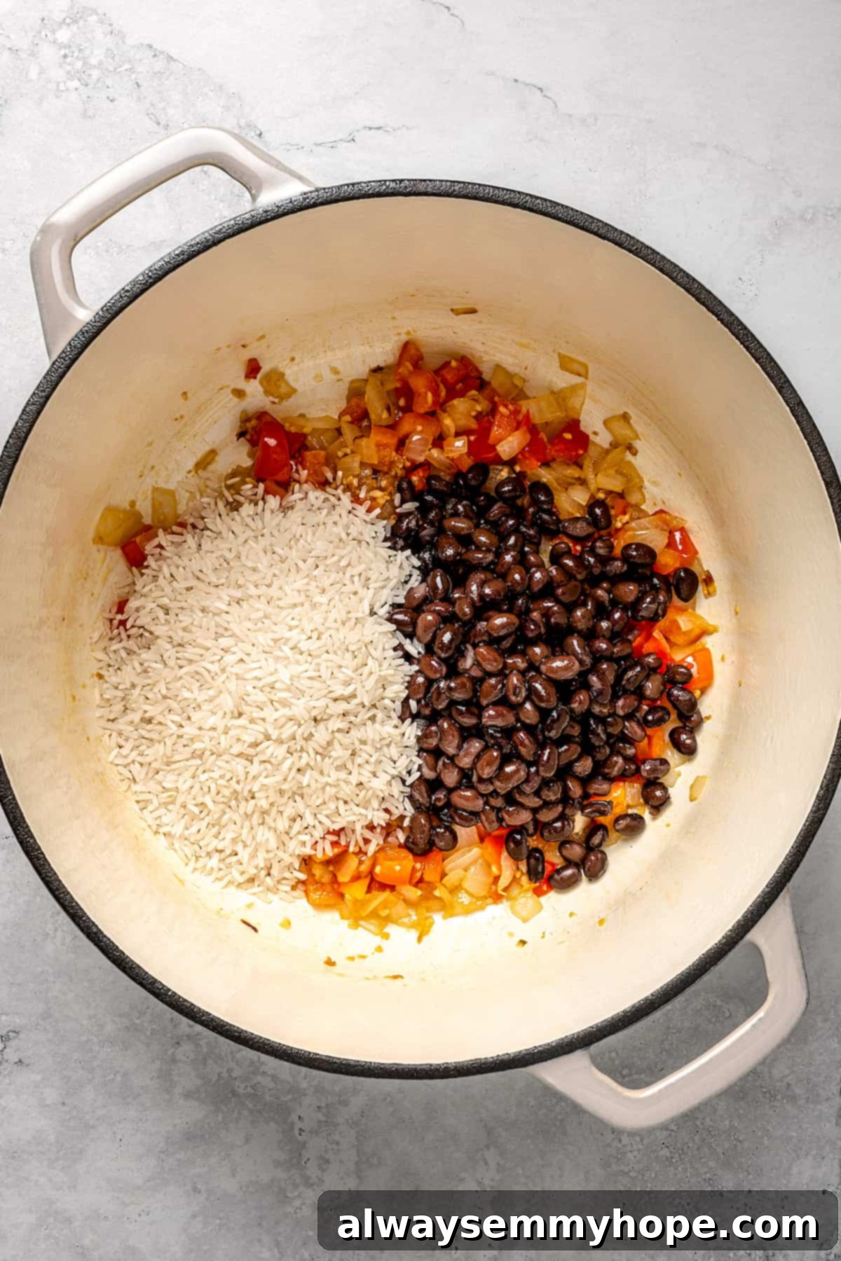 Adding rice and black beans to pot