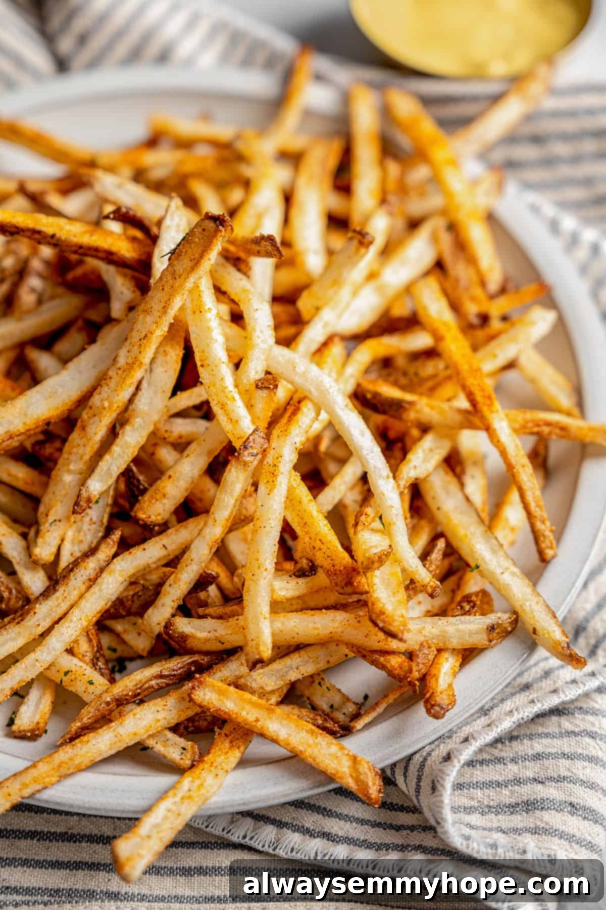 The air fryer makes these shoestring fries perfectly crispy without all the oil, and my blend of savoury seasonings makes them irresistible! Plate of shoestring fries