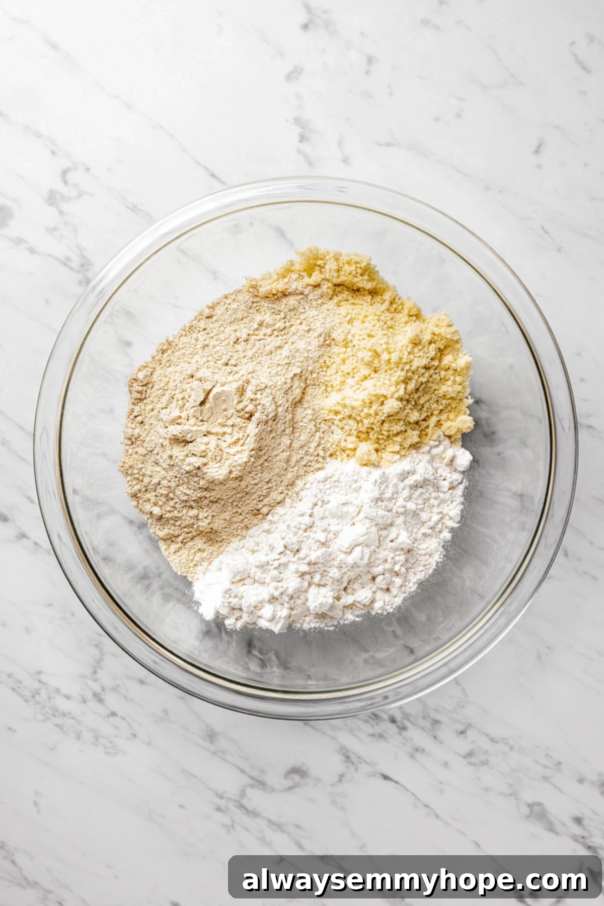Mixing Dry Ingredients for Vegan Lactation Cookies Overhead view of whisked dry ingredients (flours, sugar, spices) for vegan lactation cookies in a large mixing bowl.