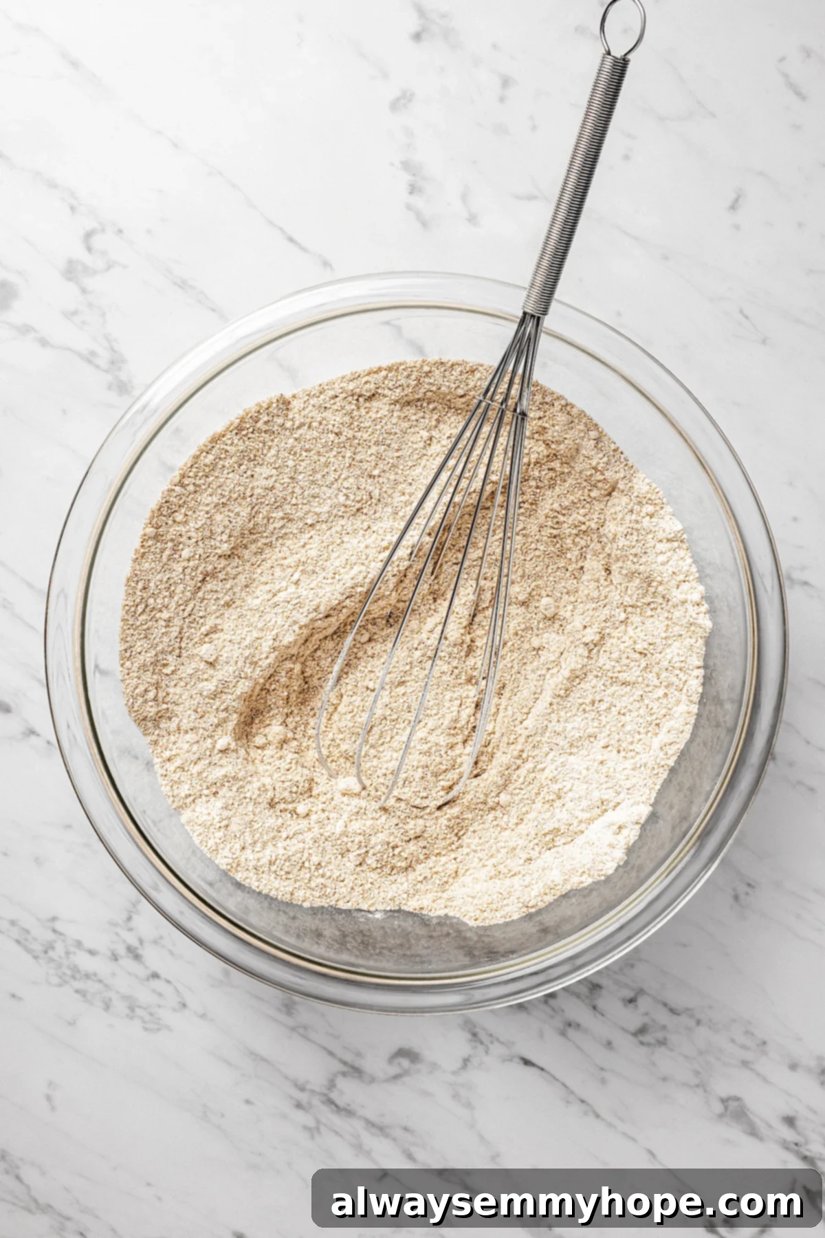 Whisking the Dry Ingredients to Perfection A closer overhead view of the well-combined dry ingredients in a mixing bowl, showing the various flours and spices.