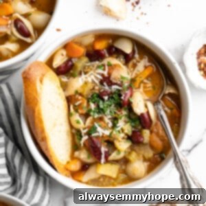 Hearty Vegetable Minestrone 2 Overhead view of bowl of minestrone soup with spoon and slice of bread