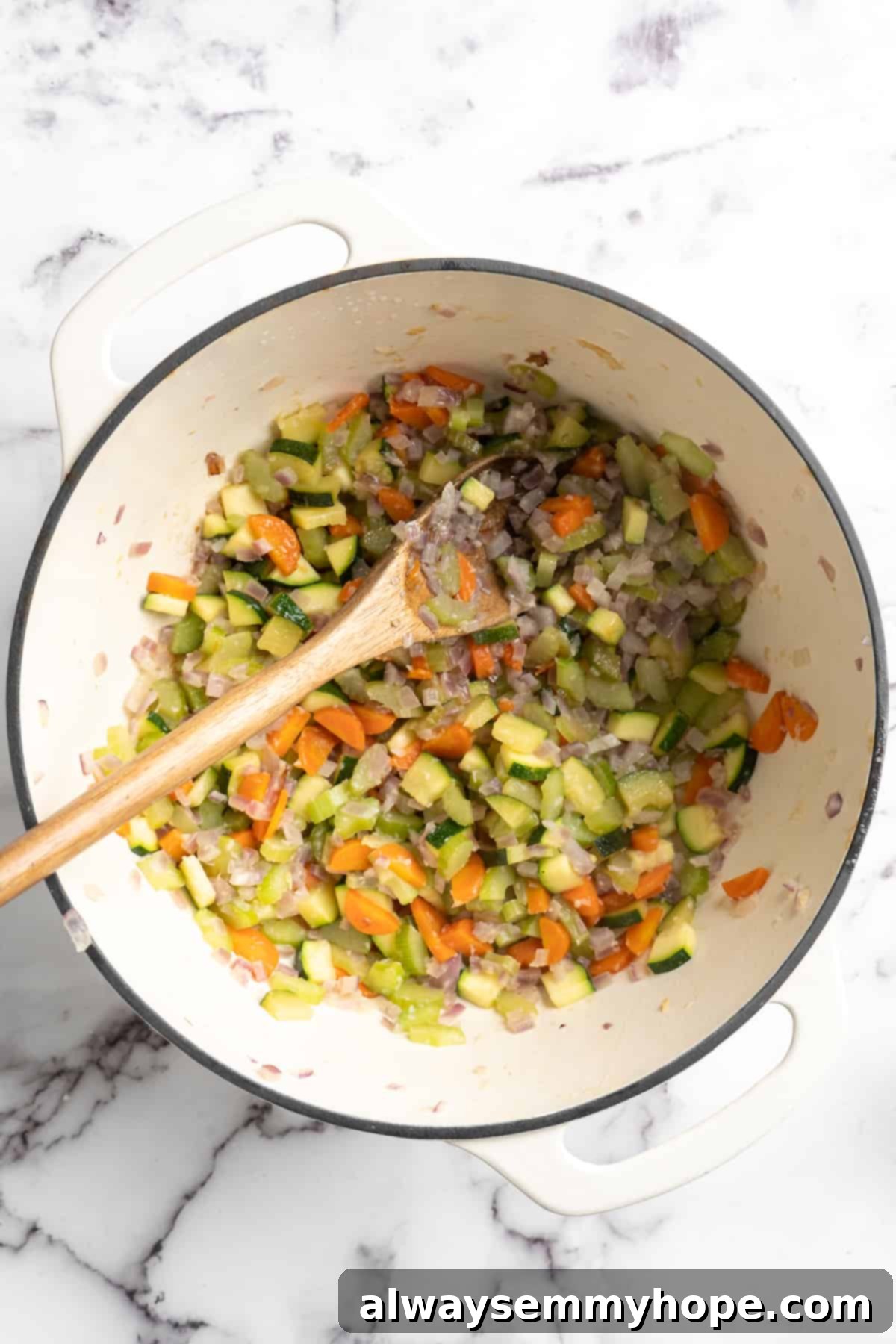 This vegetable minestrone soup is hearty comfort food at its best! Load it with veggies, beans, and pasta and enjoy a cozy one-pot meal. Overhead view of cooked vegetables for minestrone soup