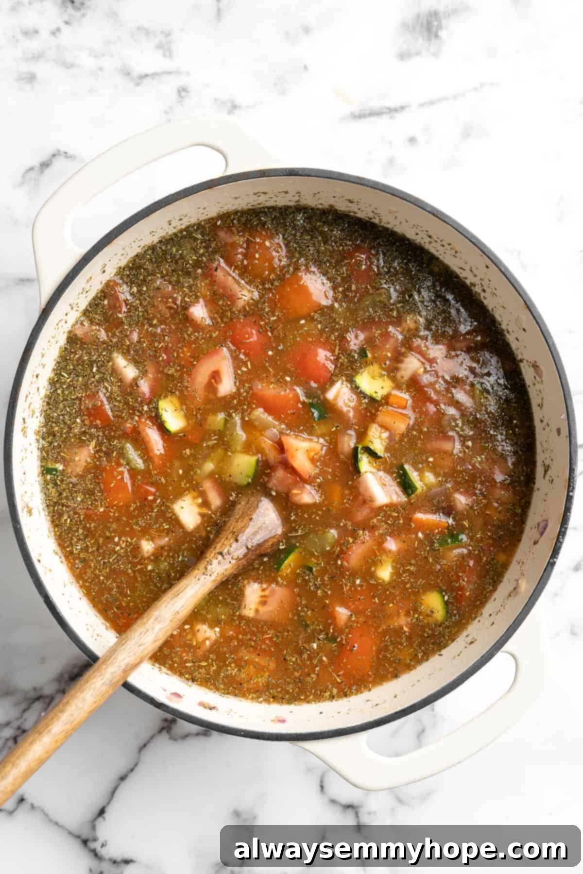This vegetable minestrone soup is hearty comfort food at its best! Load it with veggies, beans, and pasta and enjoy a cozy one-pot meal. Overhead view of vegan minestrone soup before adding pasta
