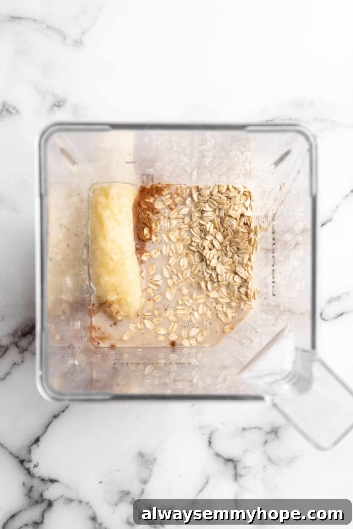 These TikTok vegan baked oats are a filling breakfast, with just a little bit of decadence thanks to the addition of dark chocolate. So easy! Overhead view of ingredients for vegan baked oats in blender