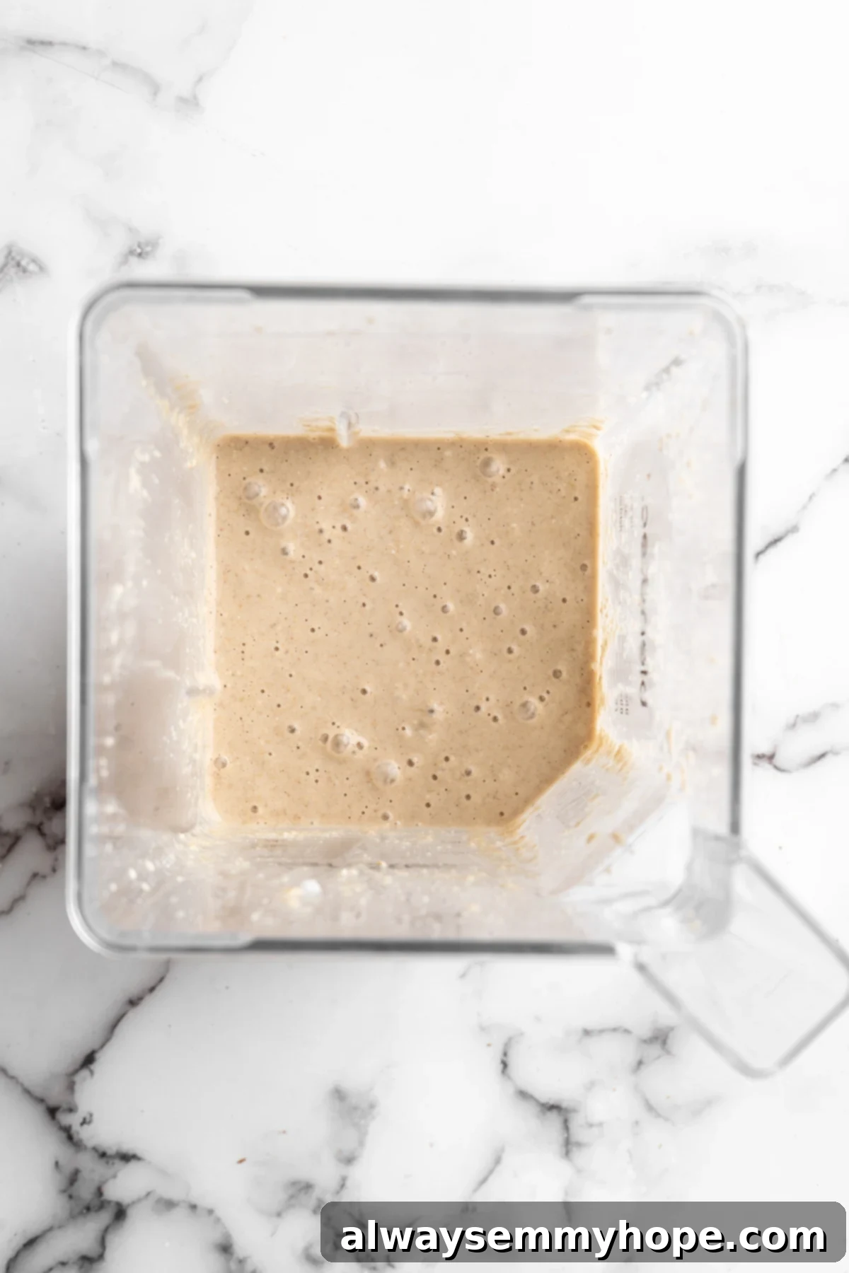 These TikTok vegan baked oats are a filling breakfast, with just a little bit of decadence thanks to the addition of dark chocolate. So easy! Overhead view of blended oat mixture in blender jar