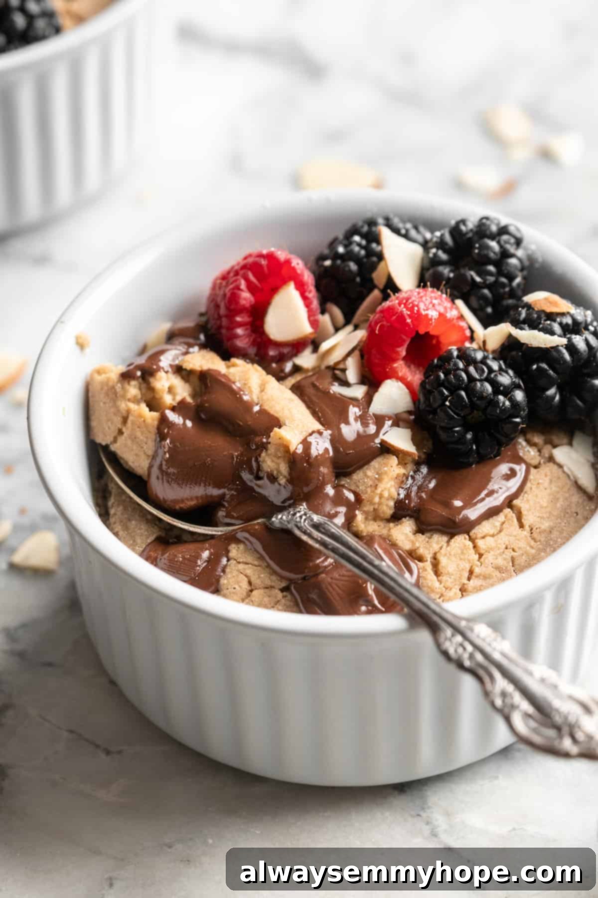 These TikTok vegan baked oats are a filling breakfast, with just a little bit of decadence thanks to the addition of dark chocolate. So easy! Spoonful of vegan baked oats set in ramekin