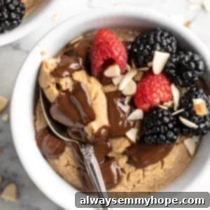 Wholesome Vegan Baked Oats 2 Overhead view of vegan TikTok baked oats with berries, chocolate, and sliced almonds