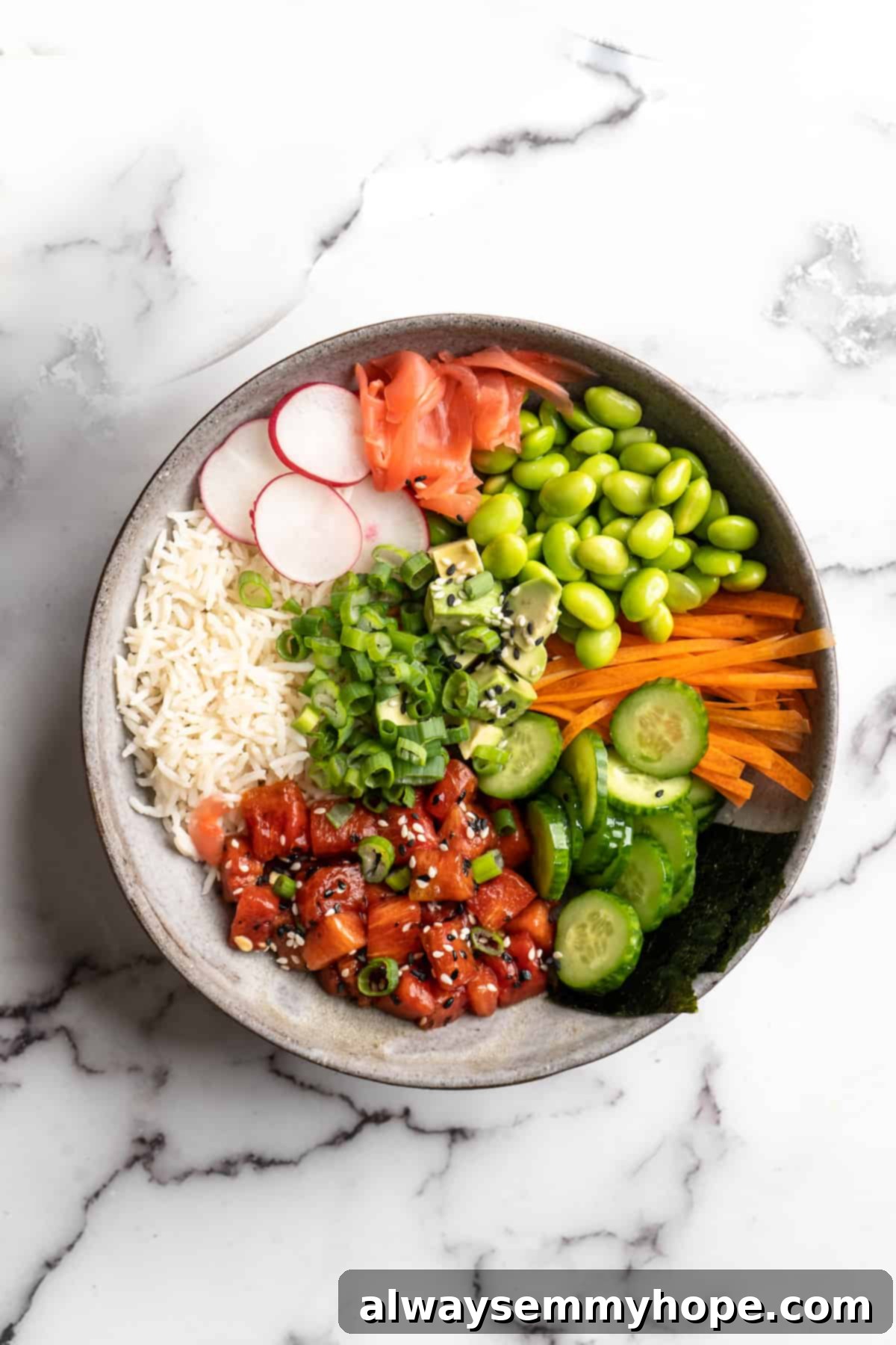 A beautifully presented vegan poke bowl featuring homemade watermelon tuna, with fresh toppings like avocado, edamame, and pickled ginger, showcasing a vibrant and healthy meal.
