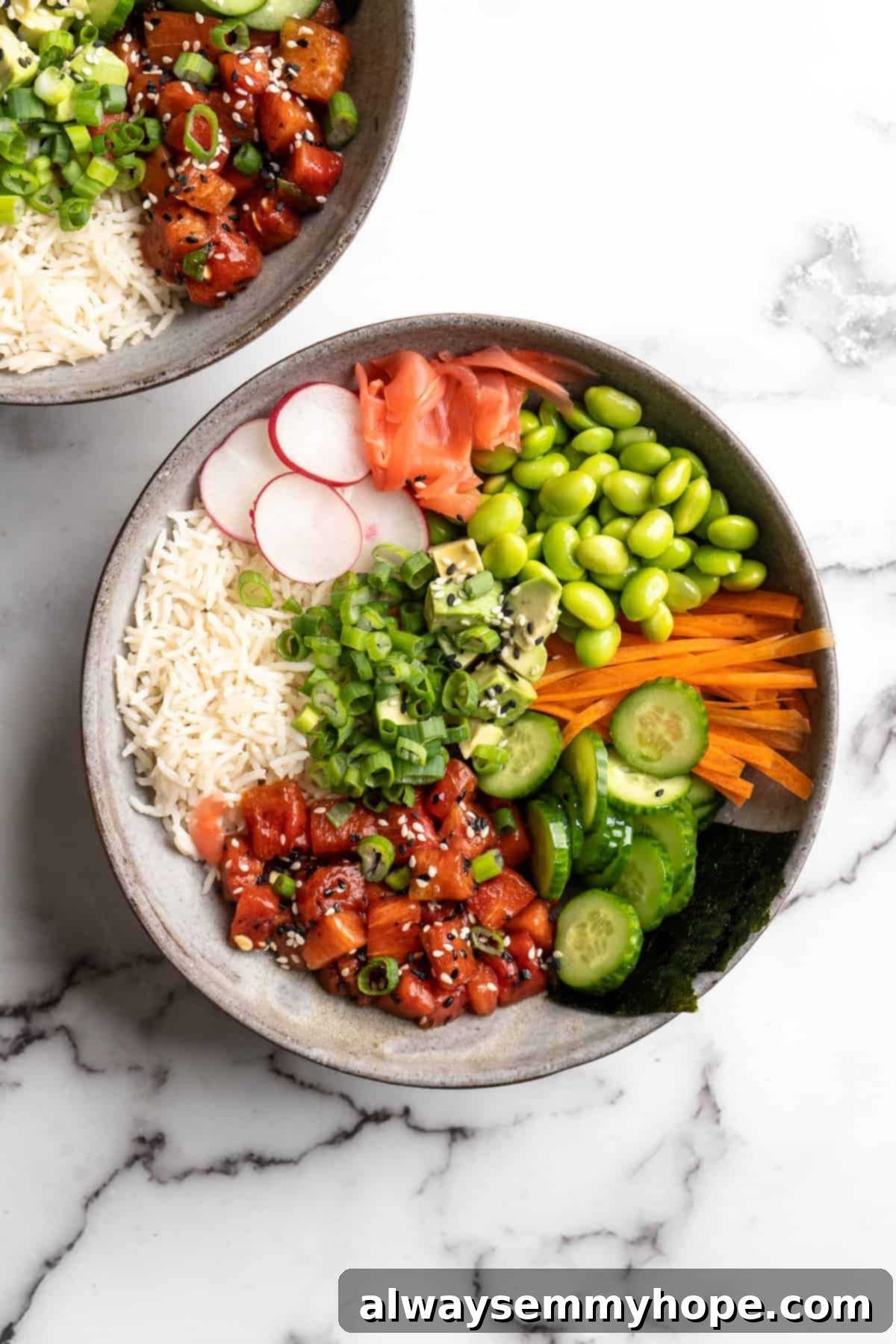 These easy vegan poke bowls are full of colour and flavour! Top a base of rice with watermelon tuna and an array of fresh toppings. So good! Assembled vegan poke bowl on marble countertop, ready to be enjoyed