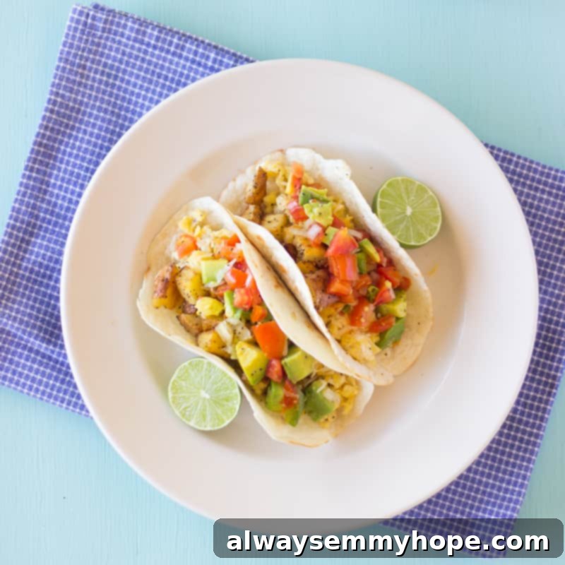 Mexican Breakfast Tacos are a hearty breakfast packed with hash potatoes, eggs and avocado pico de gallo salsa. Fresh and zesty! Overhead shot of breakfast tacos with avocado pico de gallo salsa.