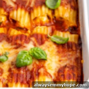 Creamy Vegan Manicotti 2 White casserole dish of vegan manicotti with fresh basil leaves