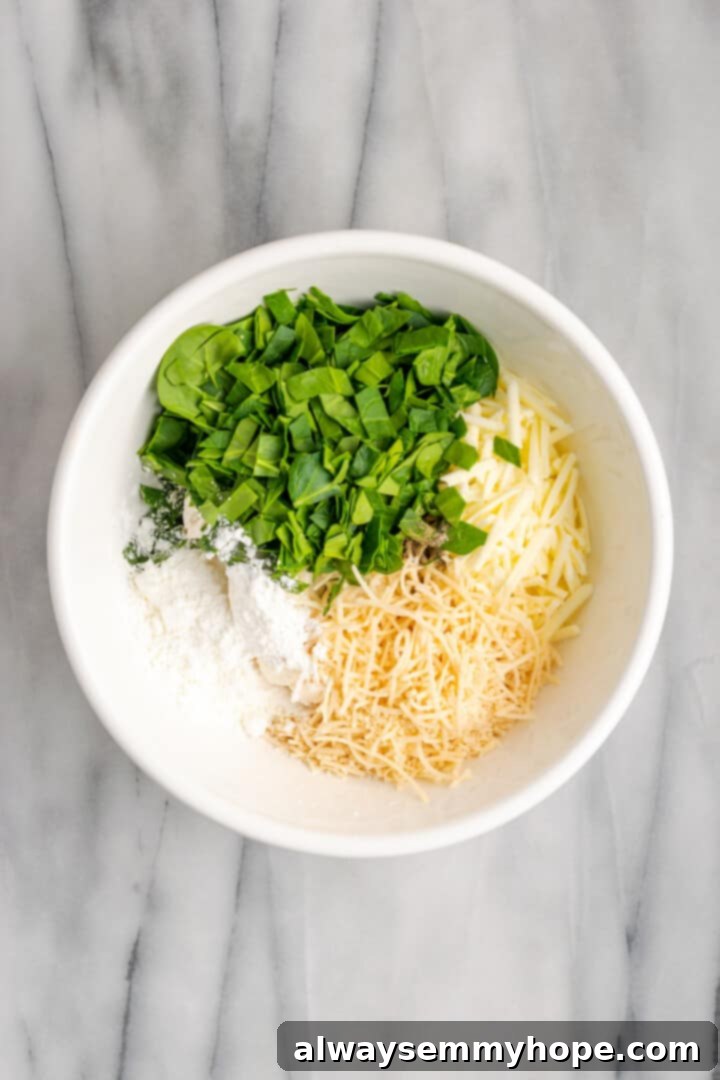 Mixing the rich, savory vegan ricotta and spinach filling for the manicotti. A vibrant display of fresh ingredients for the vegan manicotti filling, including spinach, vegan ricotta, and shredded vegan mozzarella.
