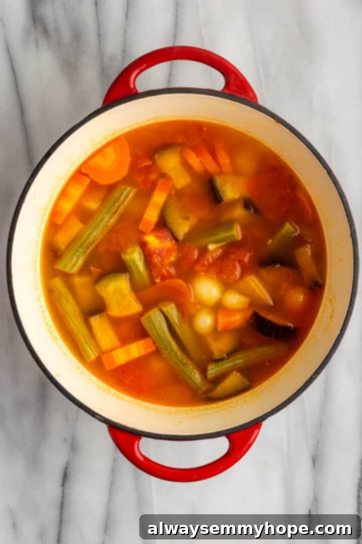 This vegan sambar is just like the sambar at your favourite Indian restaurant! Here's how to make this hearty lentil and veggie stew at home. Overhead view of vegetables in pot for making sambar