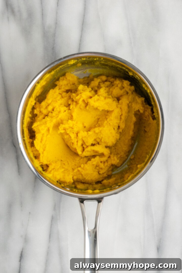 This vegan sambar is just like the sambar at your favourite Indian restaurant! Here's how to make this hearty lentil and veggie stew at home. Overhead view of mashed lentils in saucepan